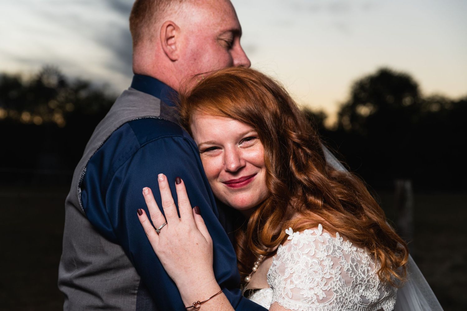 An intimate close-up moment between newlyweds at sunset.