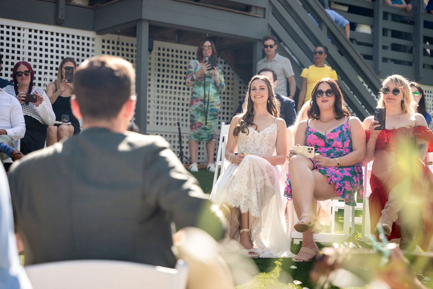 Guests watching a performance at an outdoor garden party.