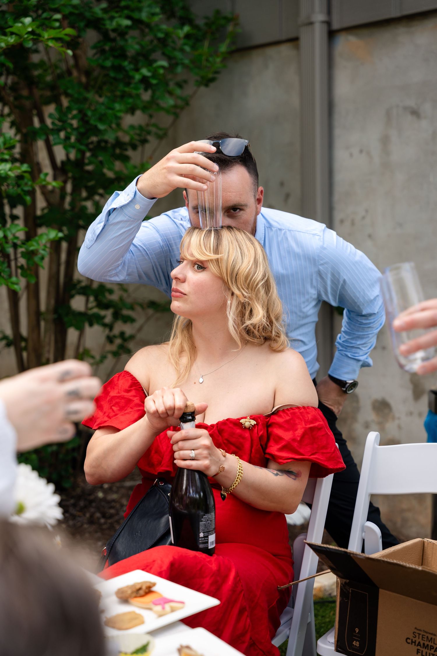People enjoying drinks and food at an outdoor party gathering.
