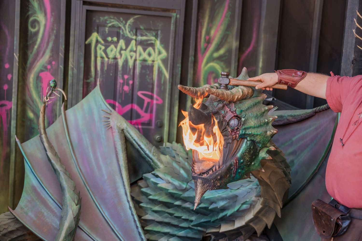 Dragon prop breathing fire during a Renaissance festival demonstration.