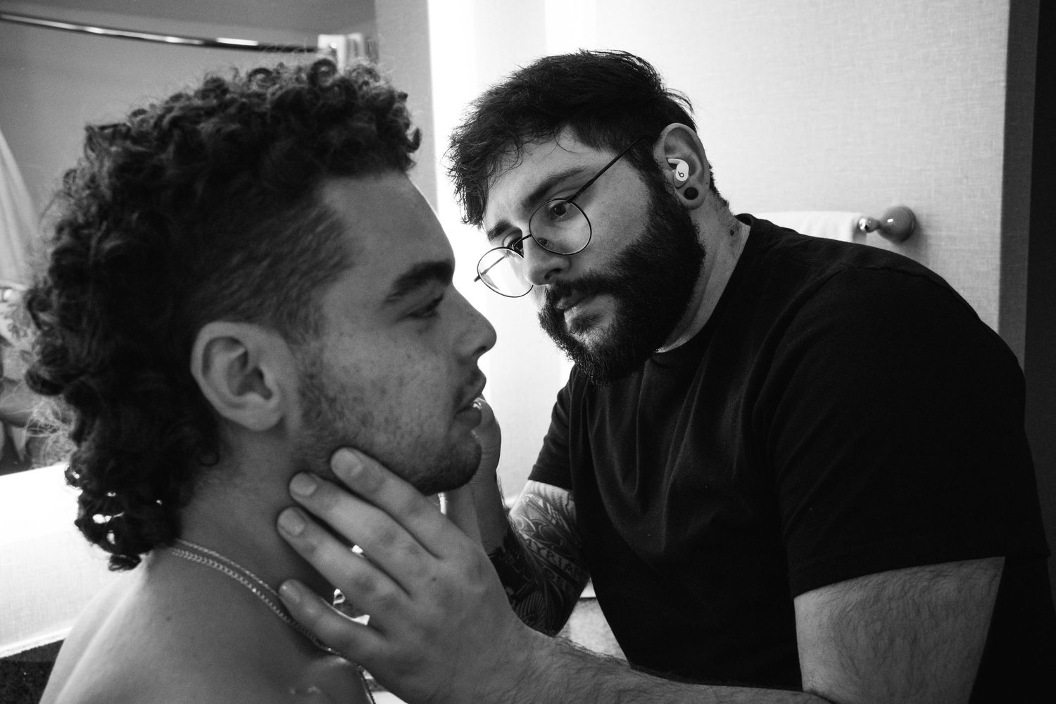 An intimate black and white portrait of two people in close conversation.