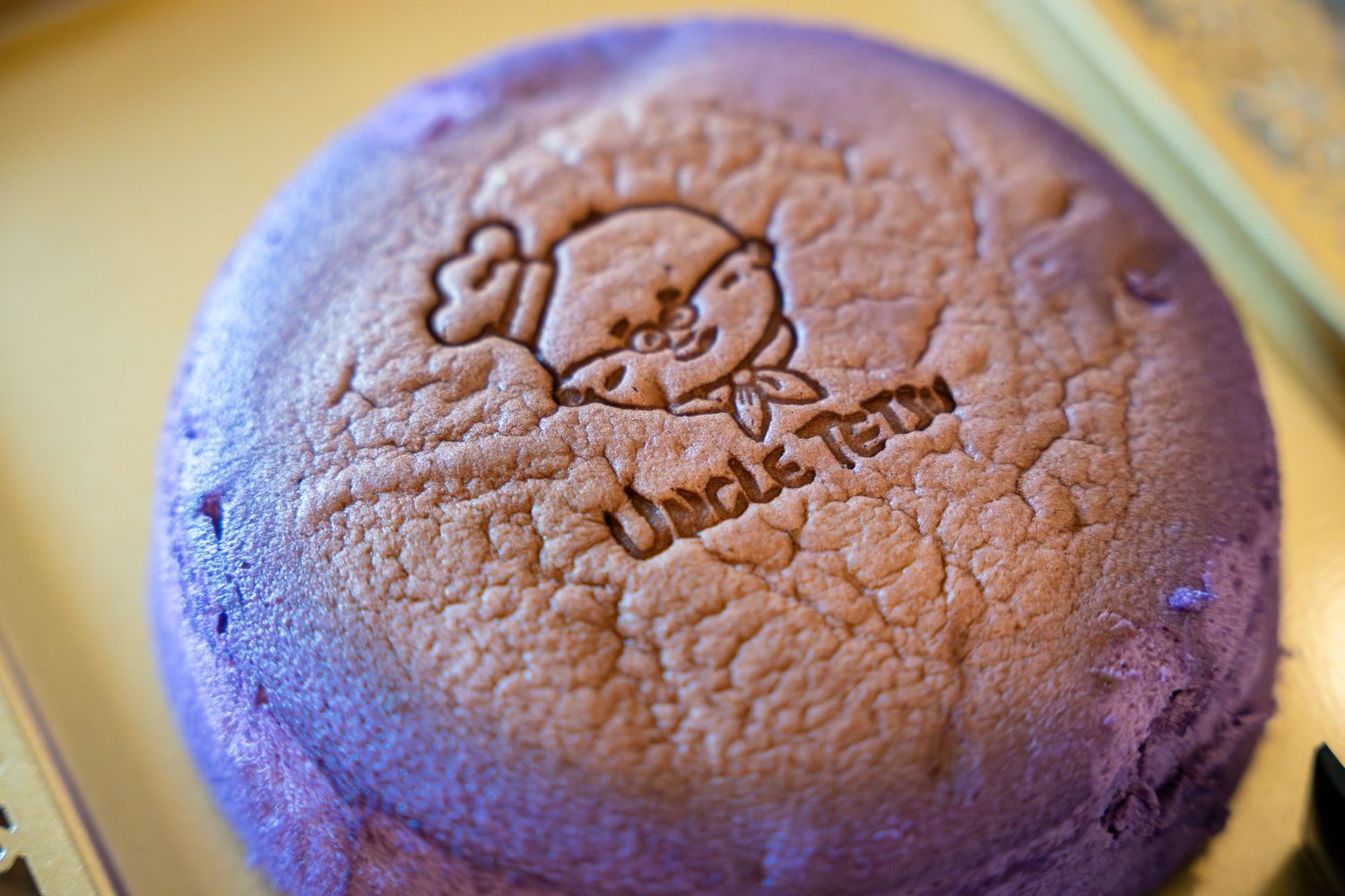 Six sequential photos show a purple baked surface cracking and dimpling as it cools over time.