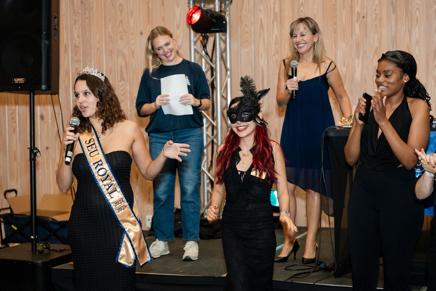 People in formal attire gathered on stage for what appears to be a performance or presentation.