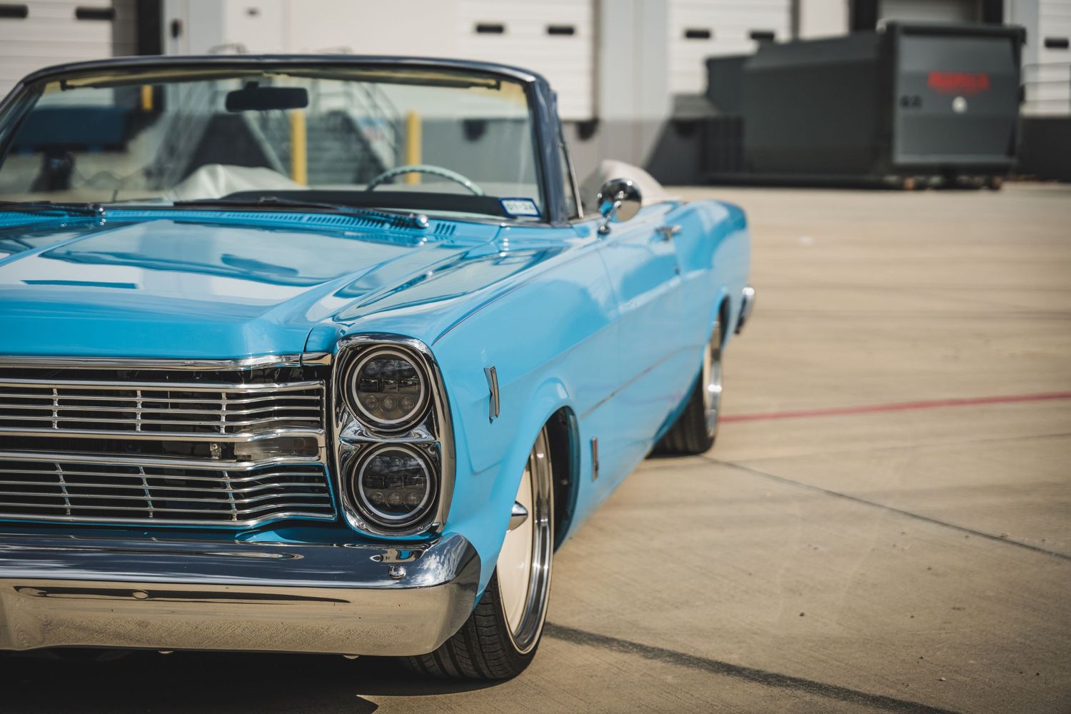 Restored baby blue classic Ford Galaxie convertible with chrome detailing.