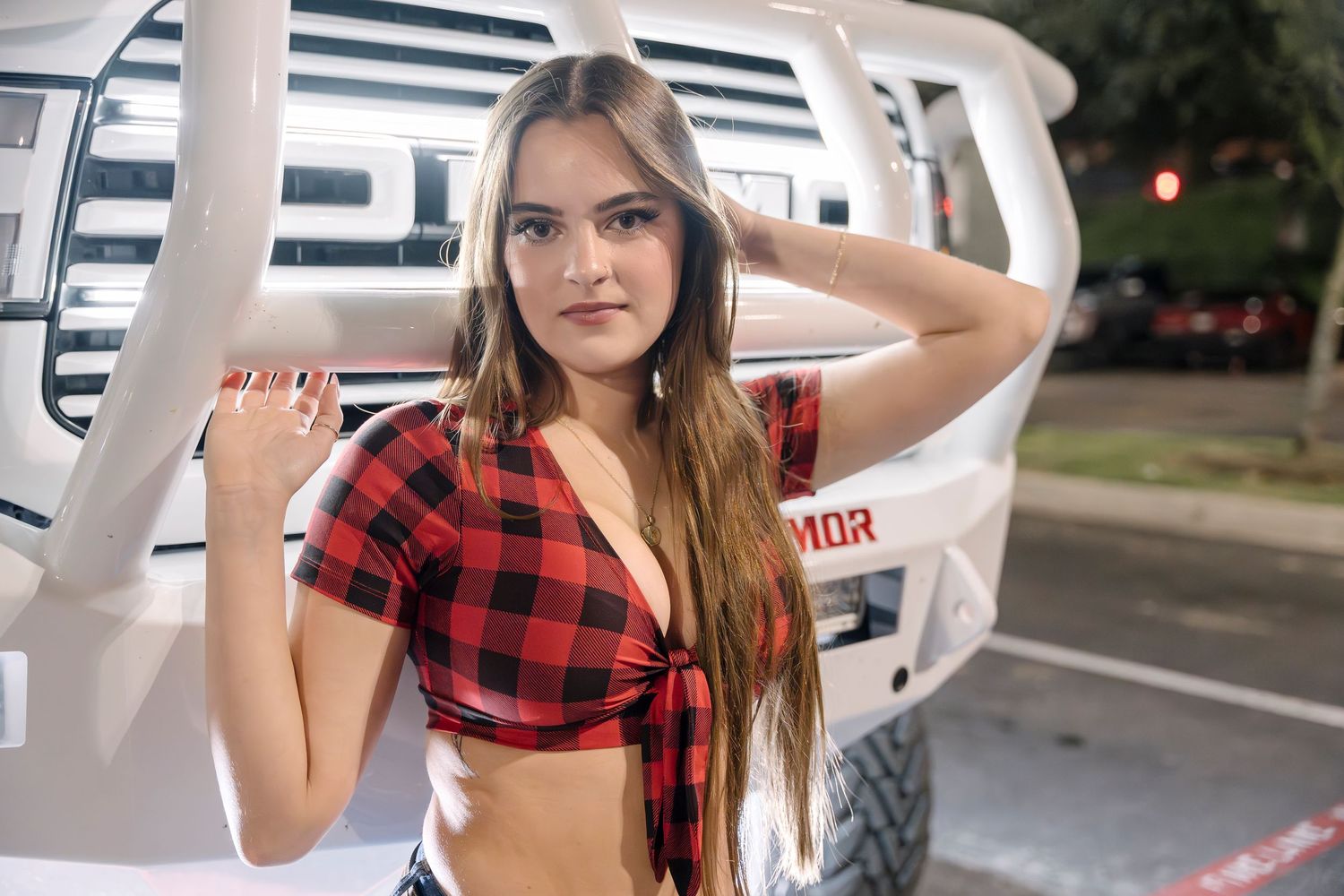 Red buffalo plaid tied crop top shown against white truck exterior.