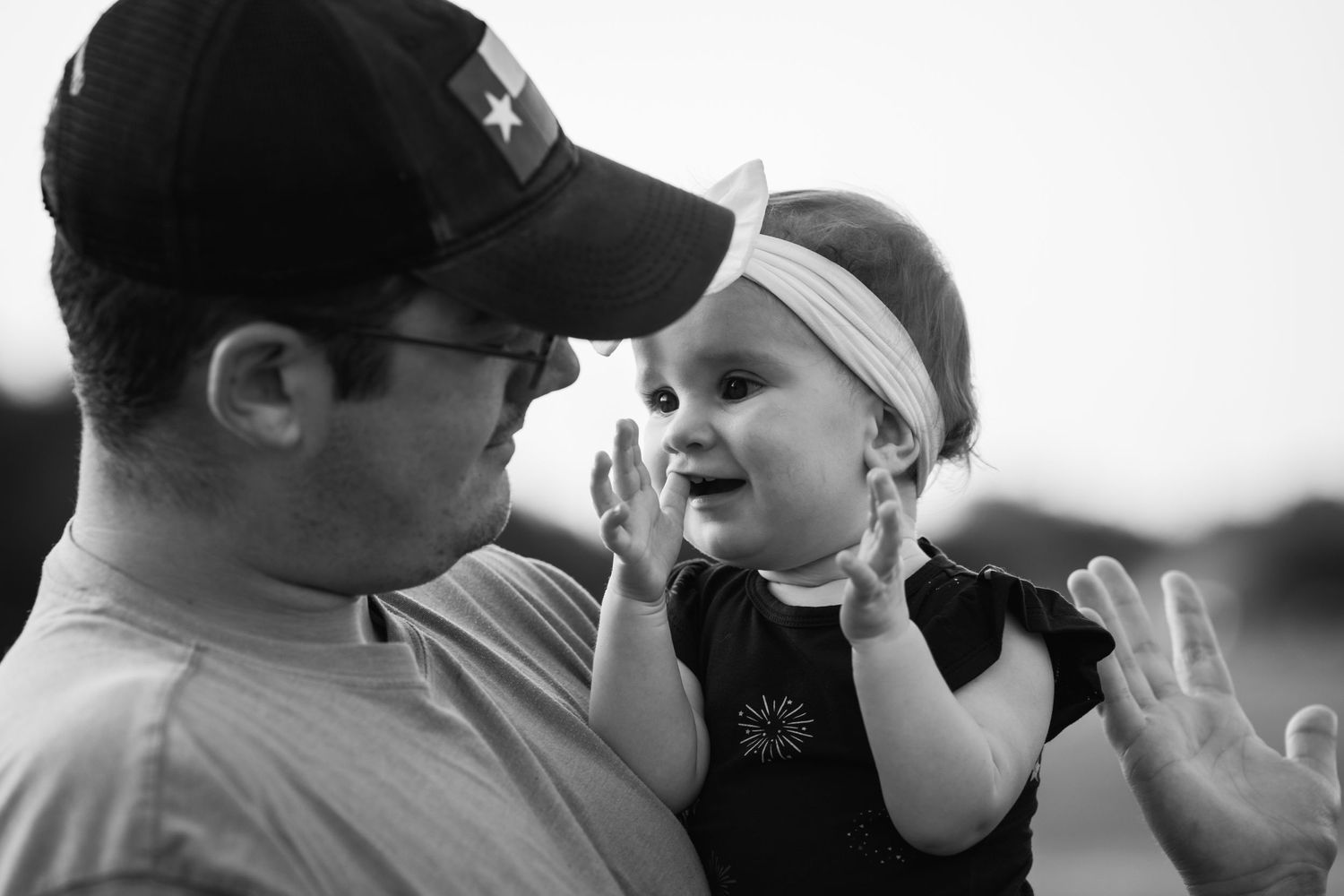 Black and white portrait of tender moment between parent and child.