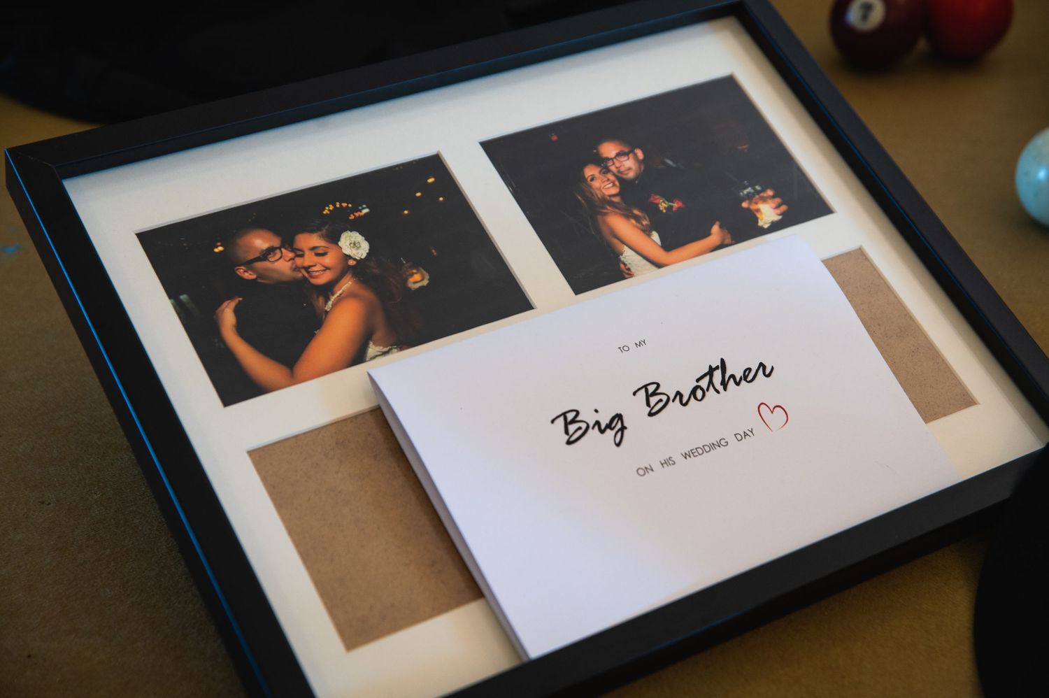 Framed 'Big Brother' photo collage display with heart decoration.