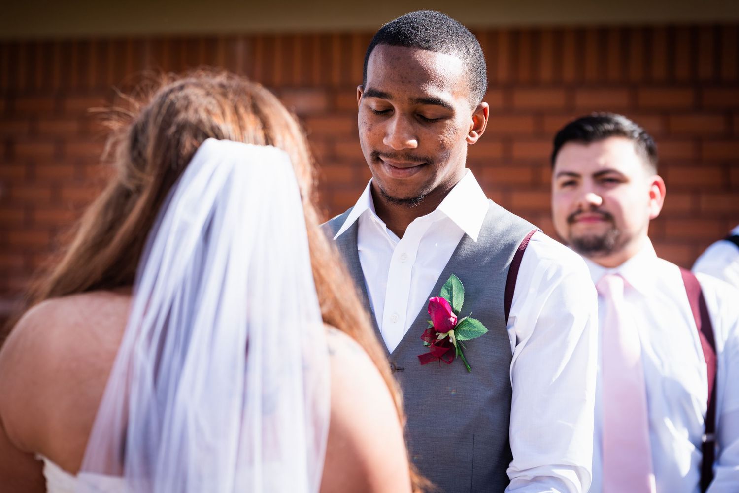 A tender moment between the couple during their wedding ceremony.