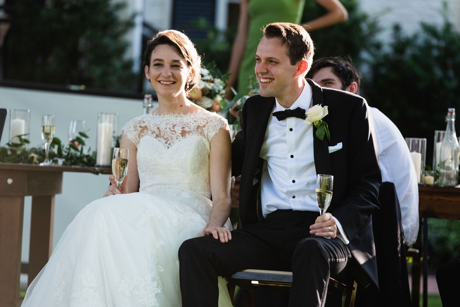 Newlyweds sharing a joyful moment together at their outdoor reception.