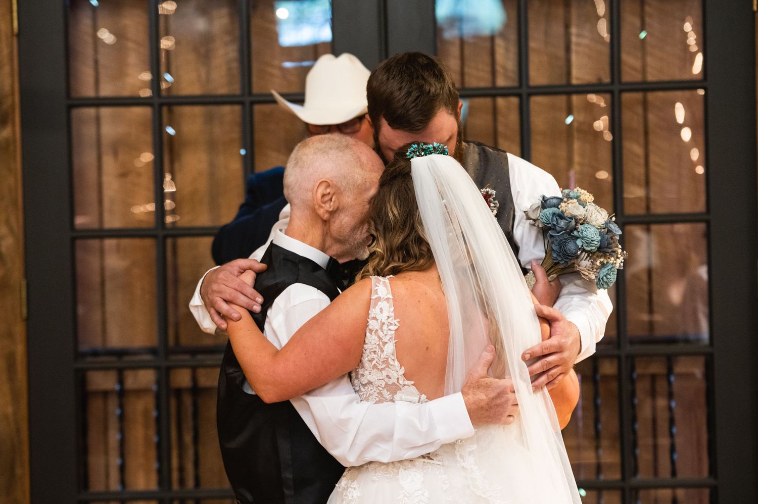 An emotional moment shared during a wedding ceremony with the couple embracing.