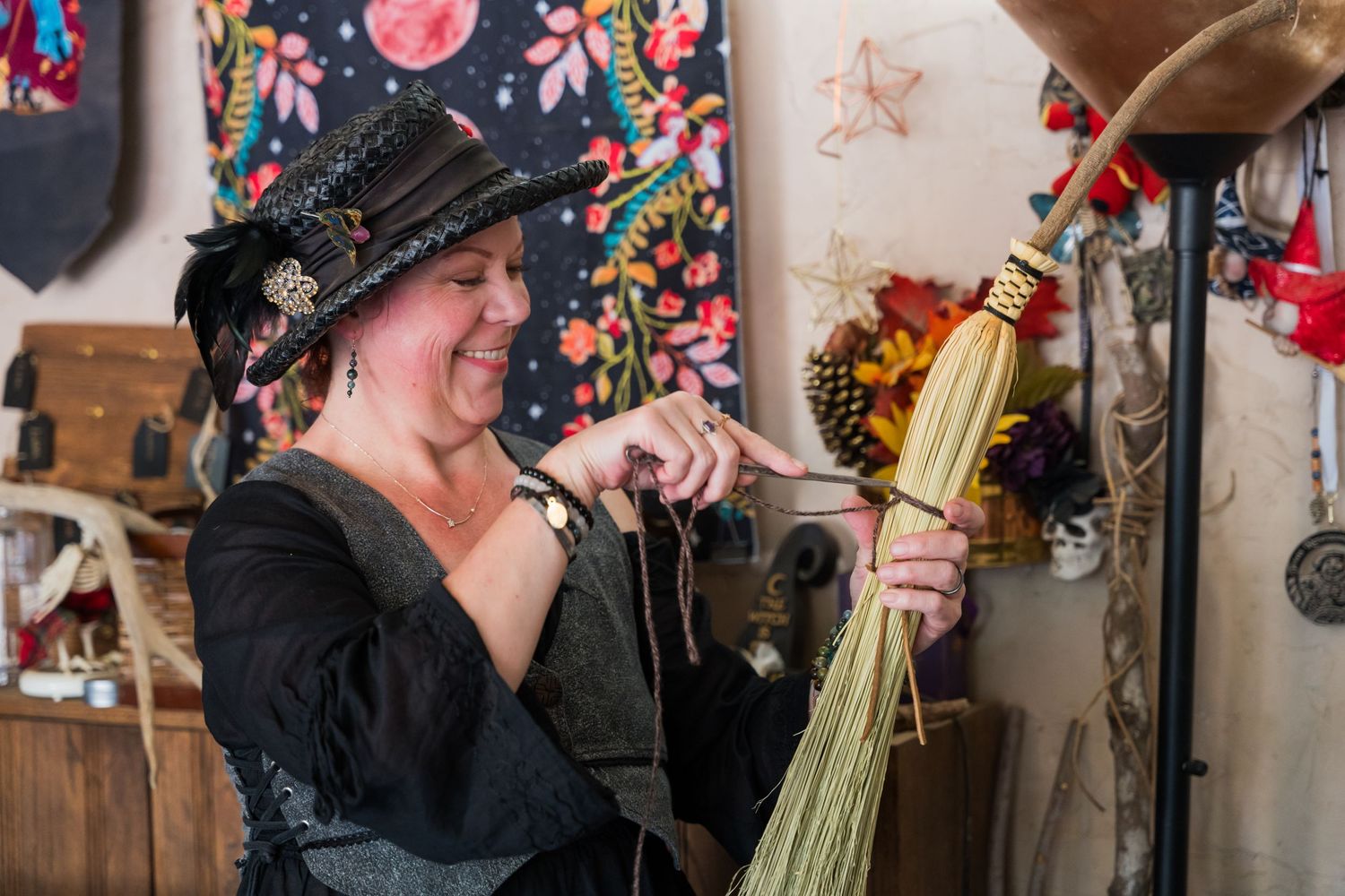 Performer in renaissance attire holds traditional musical instruments at a festival.