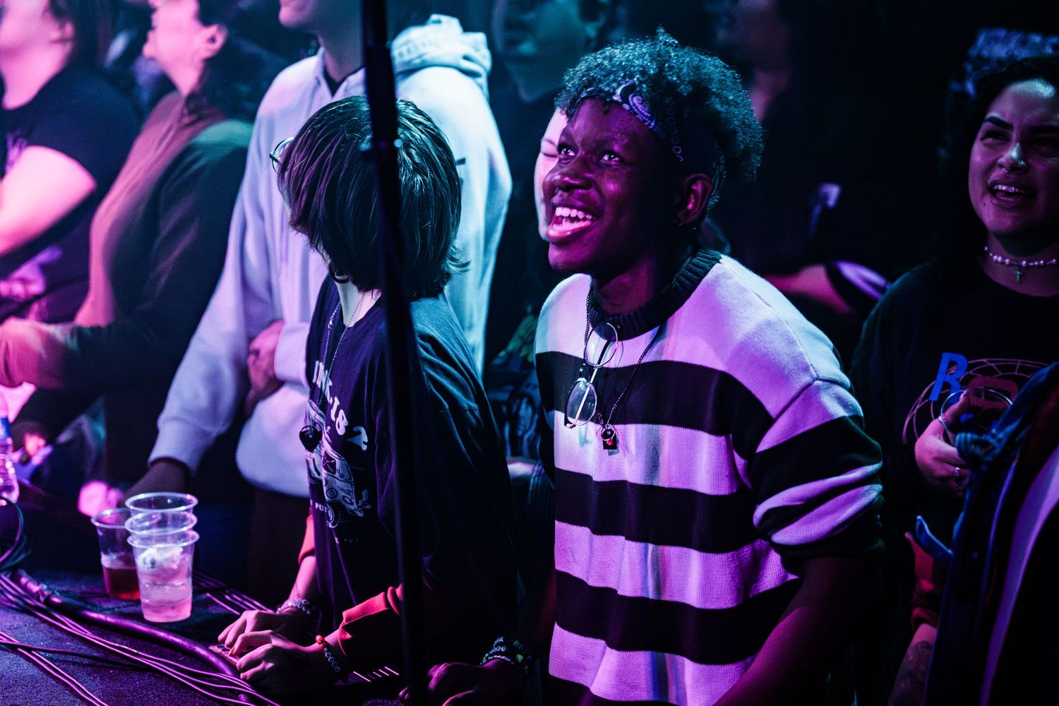 Concert audience members laughing and enjoying live performance.