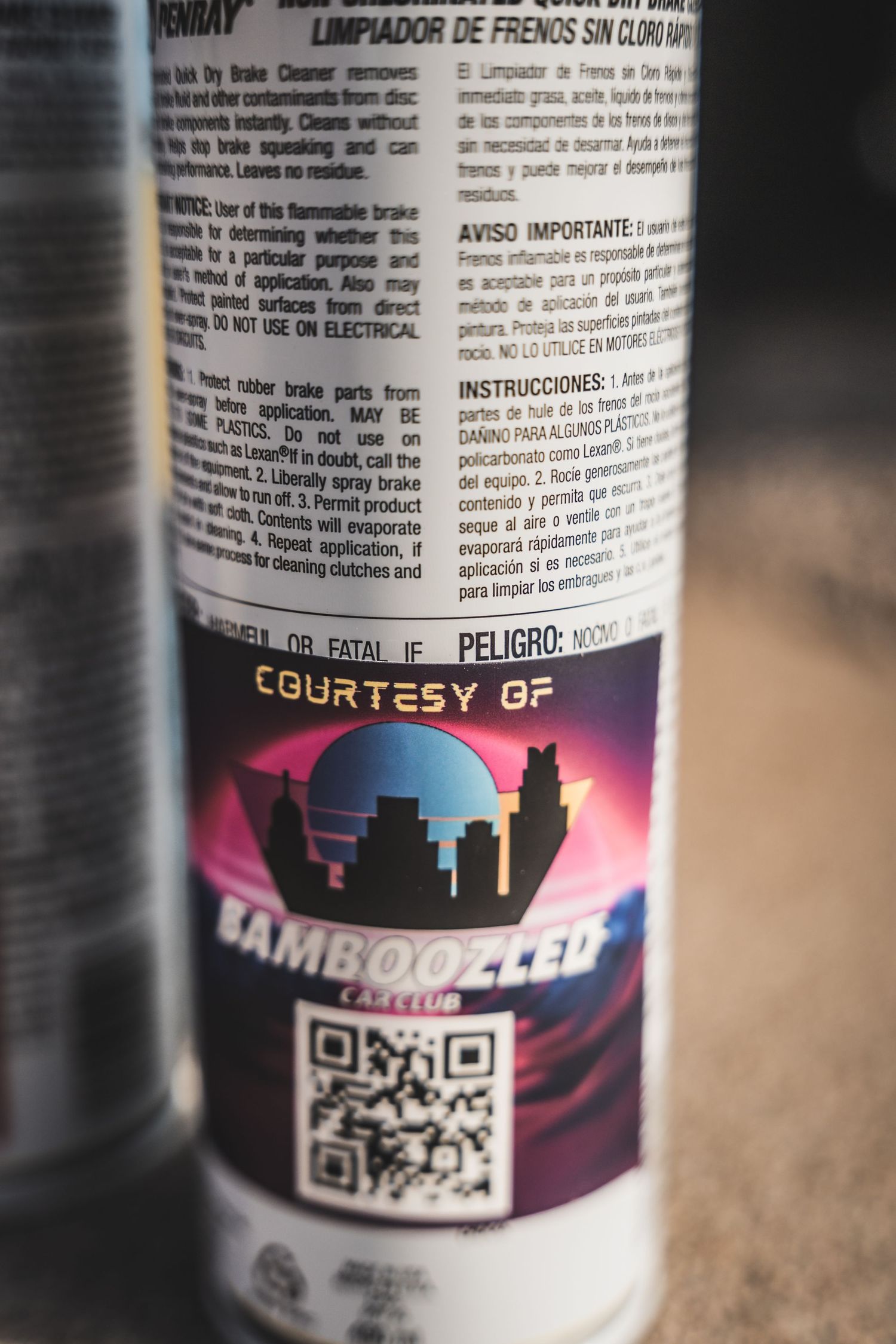 Close-up of a Bamboozler club sticker with QR code and cityscape logo on a product label.