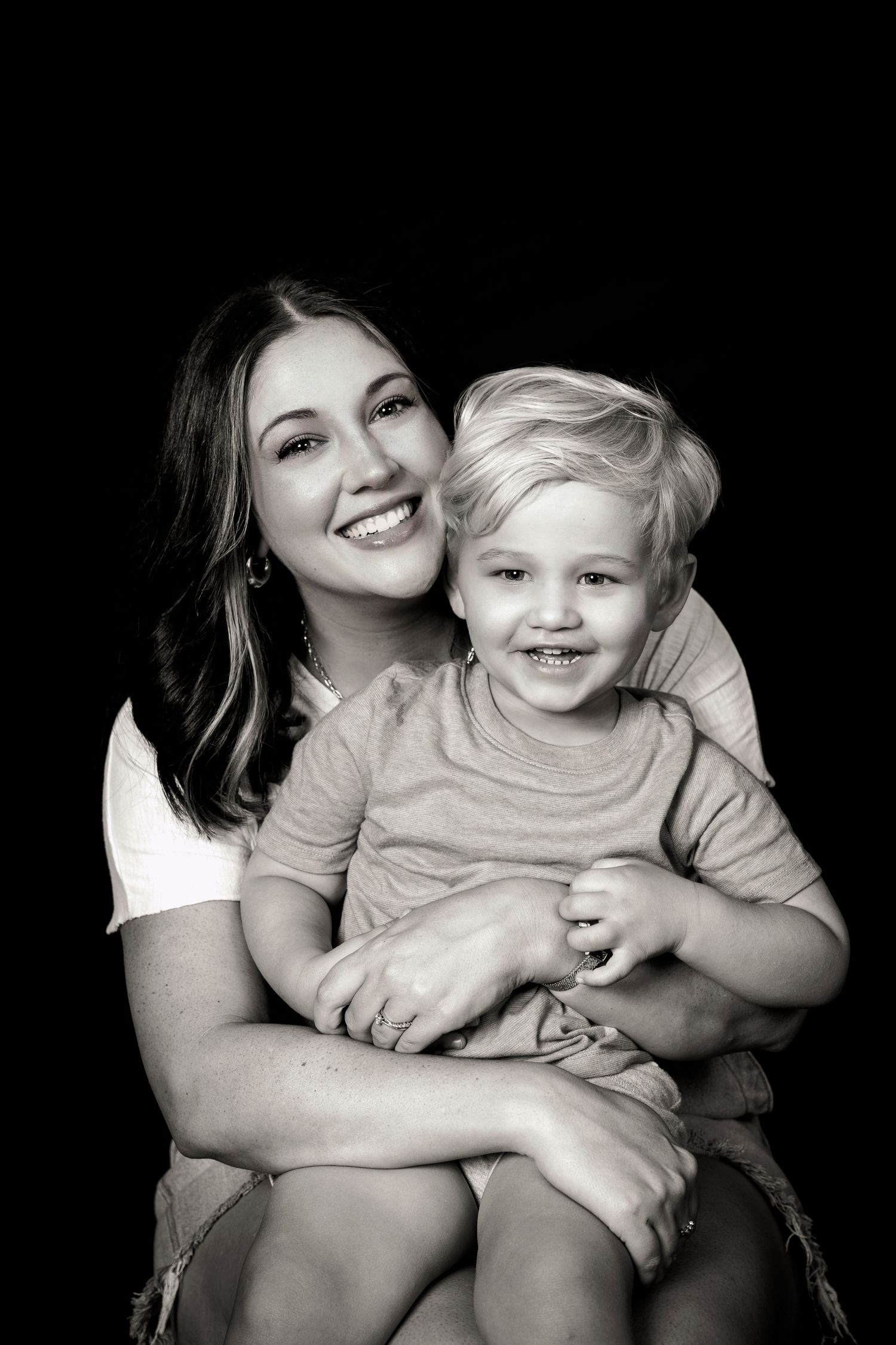 Intimate black and white portrait capturing genuine laughter and affection.