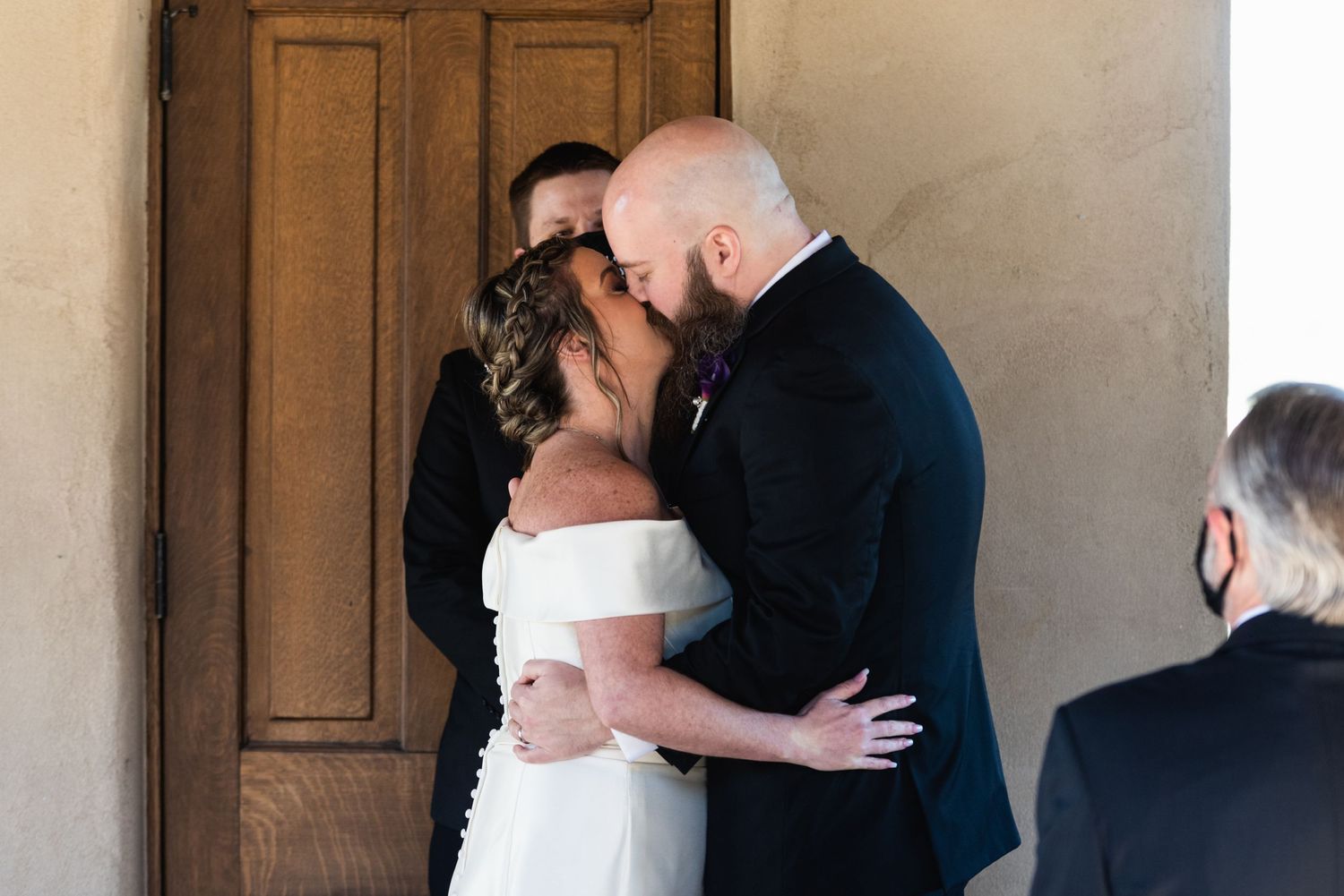 Newlyweds share their first kiss as married couple during intimate ceremony.