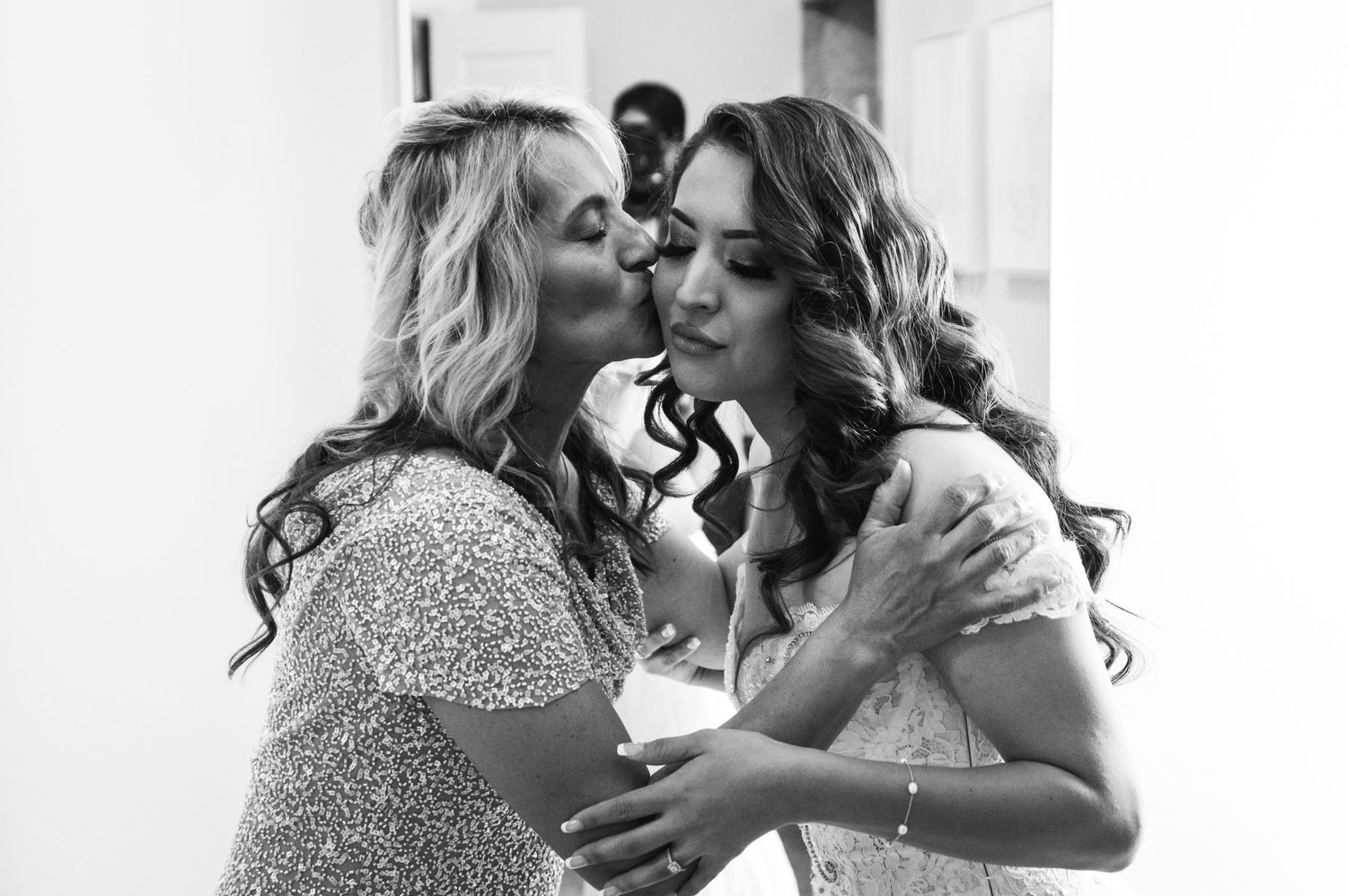 Tender black and white moment shared during wedding preparations.