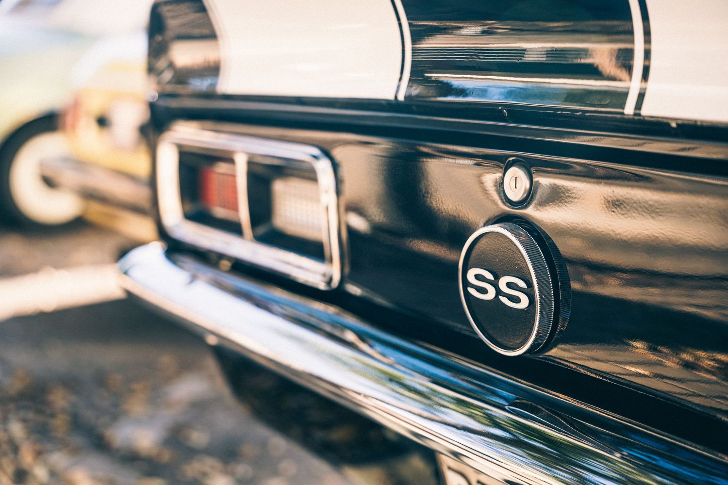 Close-up of classic Chevrolet SS badge and trim on black vehicle.