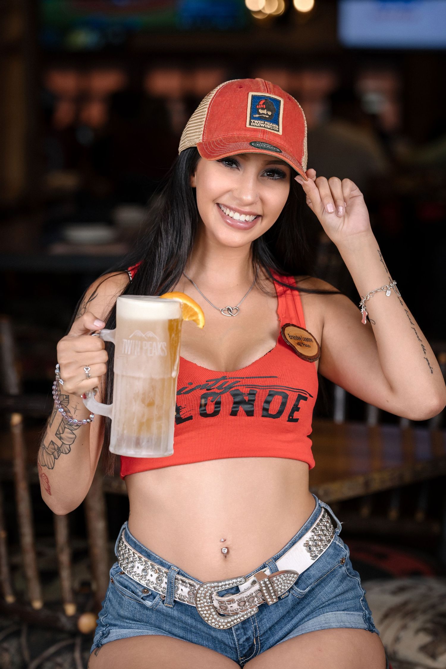 Bar promotional photo with beer and casual summer attire.