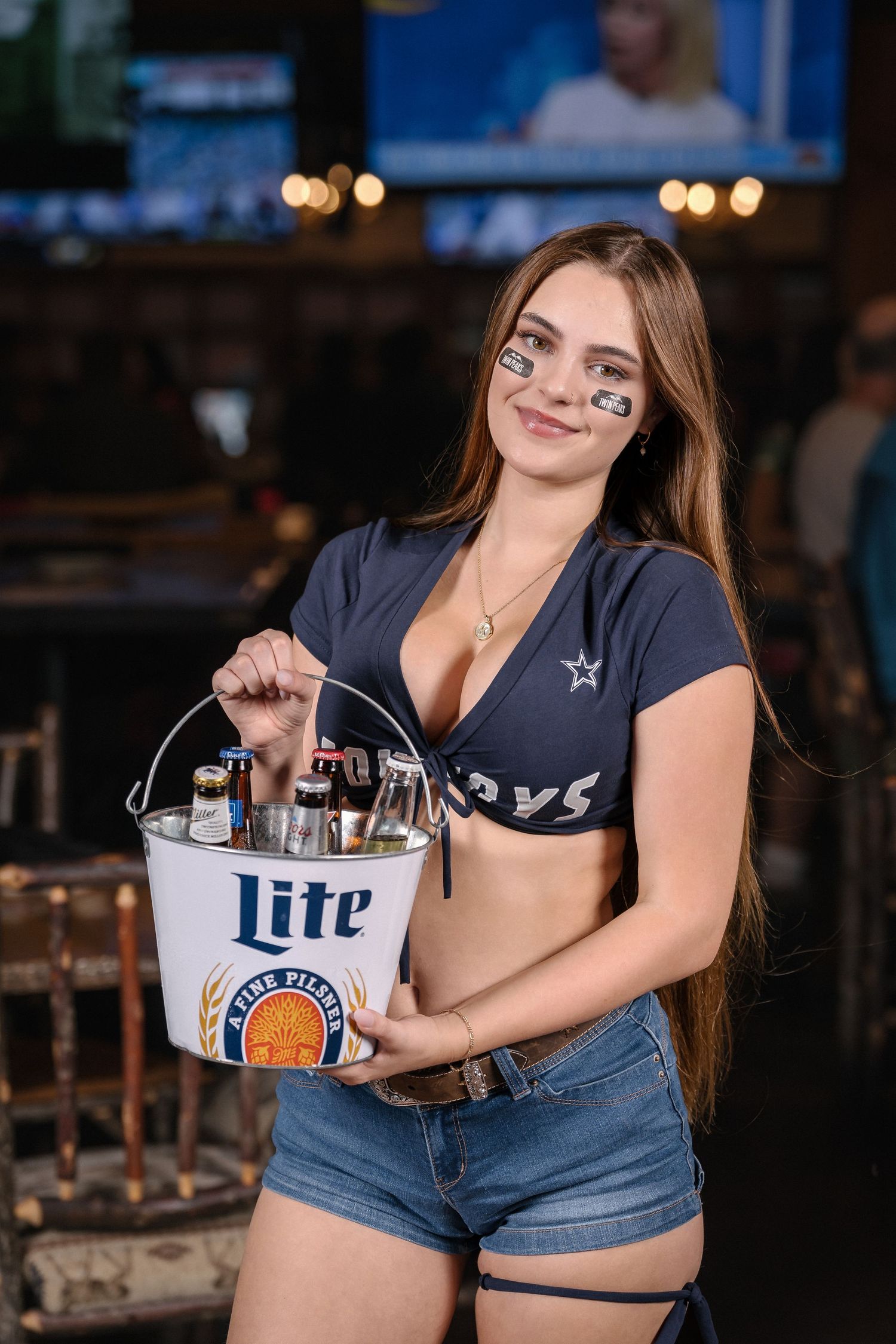 Bar promotional photo featuring Miller Lite beer bucket and casual sports attire.