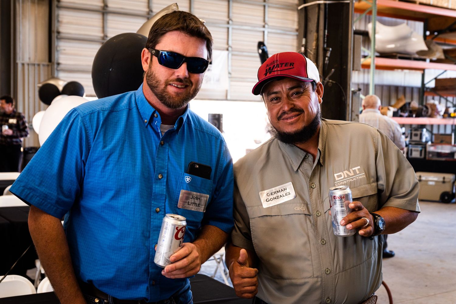 Two people enjoying beverages at an outdoor event.