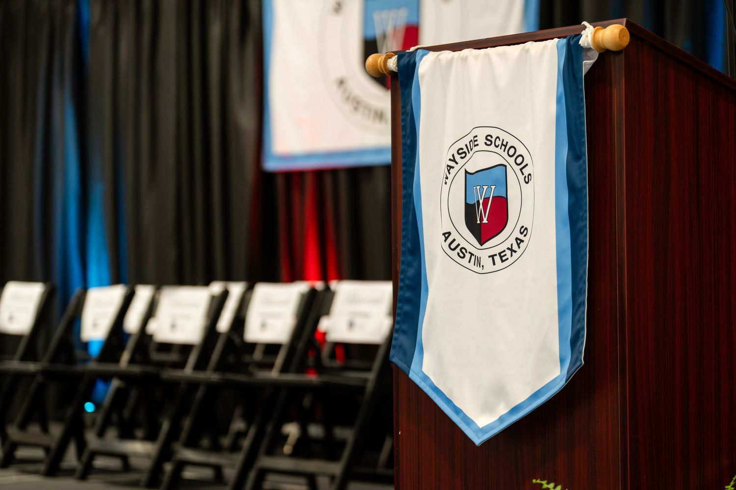 Blue and white ceremonial banner displayed at graduation ceremony.