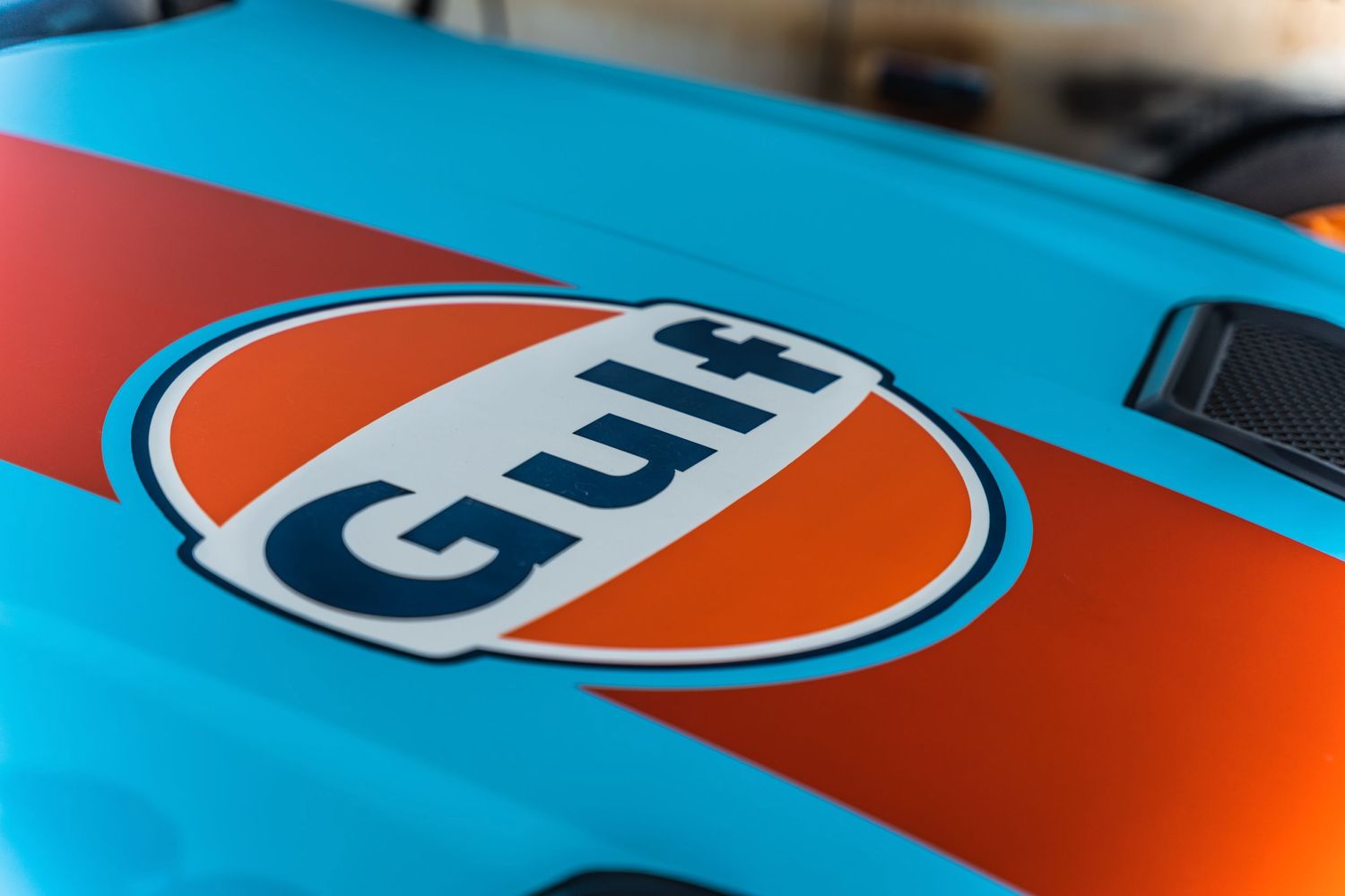 Classic Gulf Oil racing livery logo detail on light blue automotive paint.