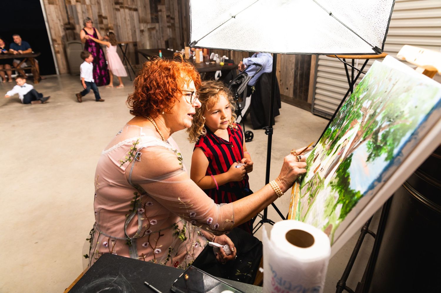 An art lesson session shows painting instruction taking place at an easel with a nature-themed artwork in progress.