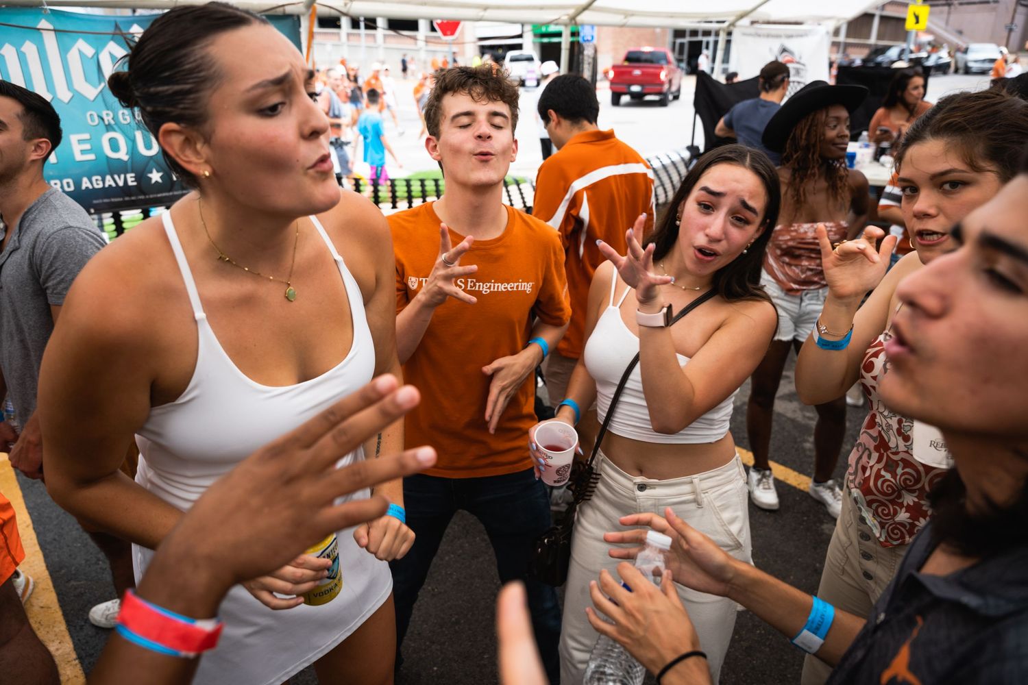 Group of young people dancing and enjoying themselves at a lively outdoor gathering.