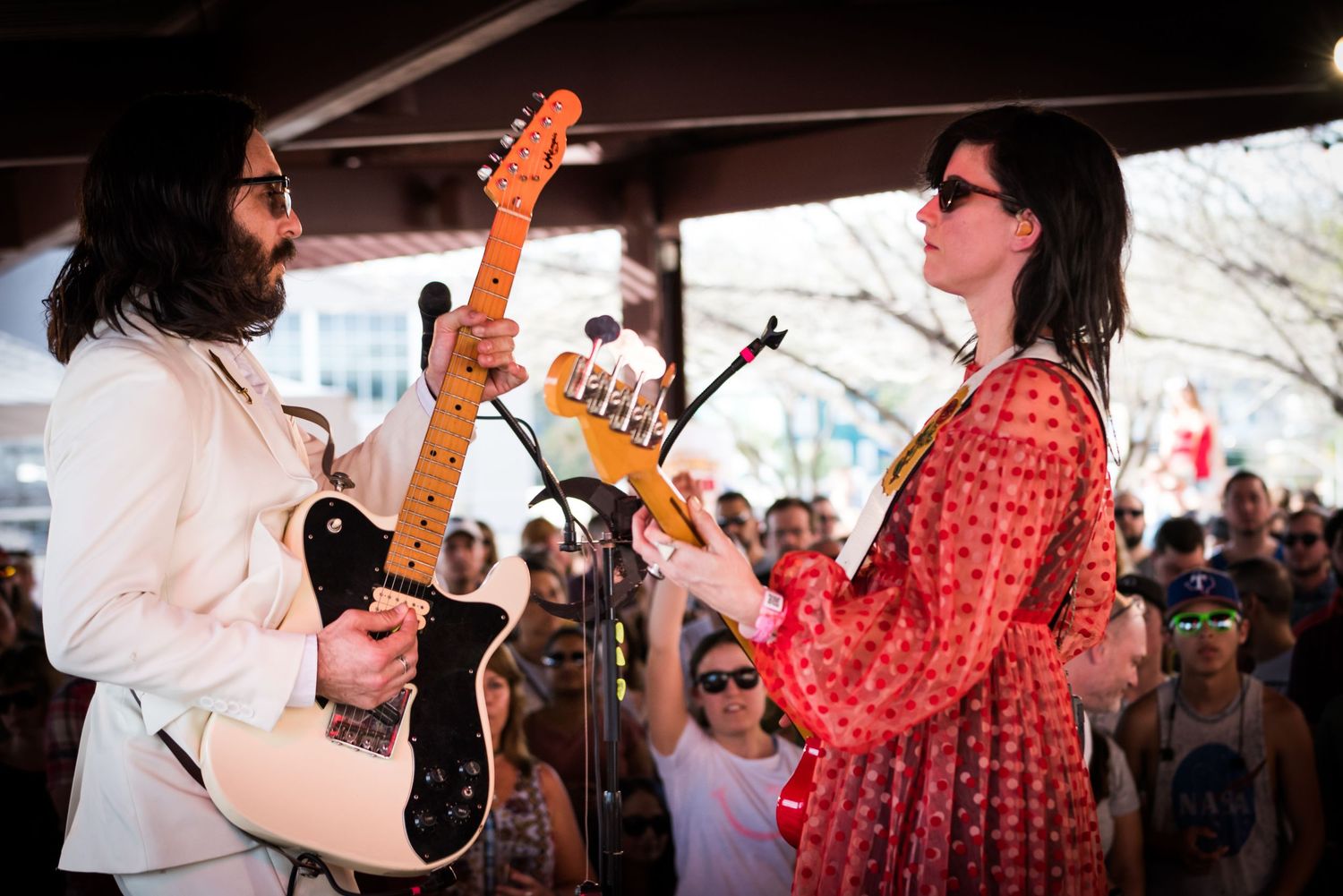 A series of live music performance photos showing musicians on stage with instruments and a crowd in the background.
