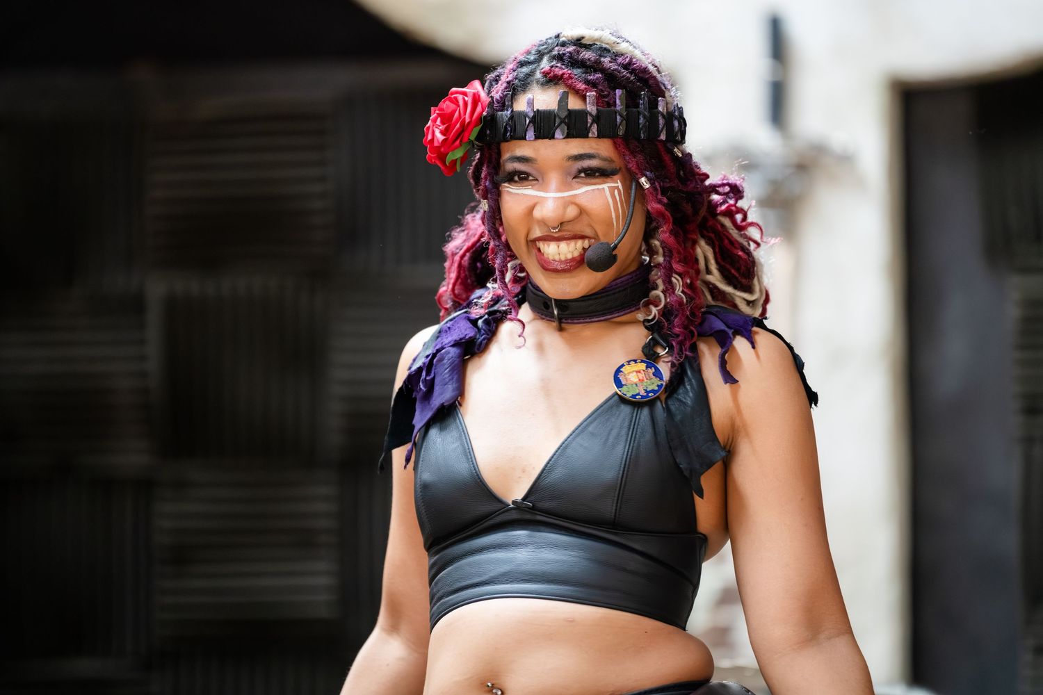 A person wearing a black sports bra and colorful braided hair poses in multiple photos against a dark background.