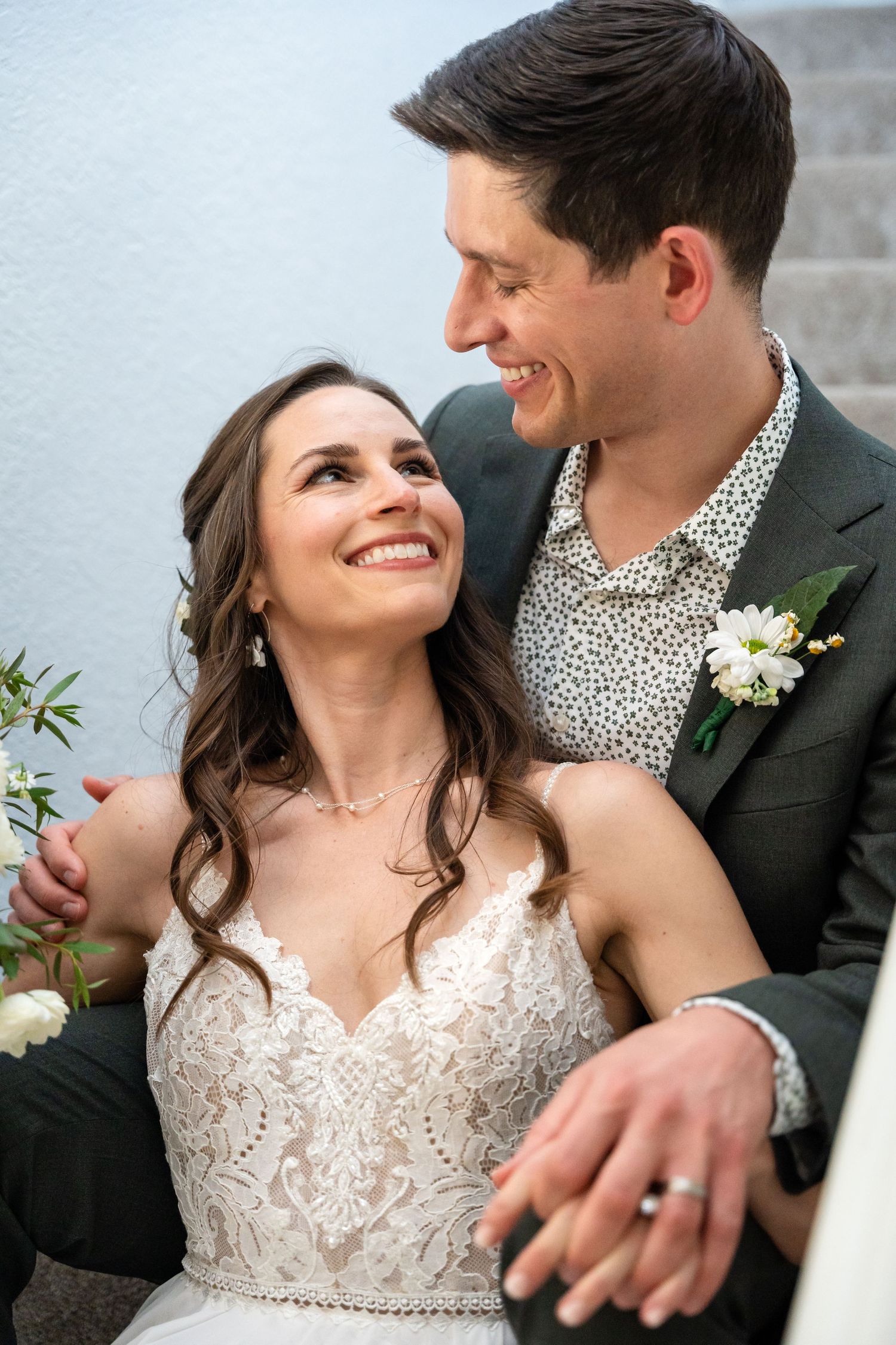 An intimate wedding portrait capturing a loving moment between a couple in formal attire.