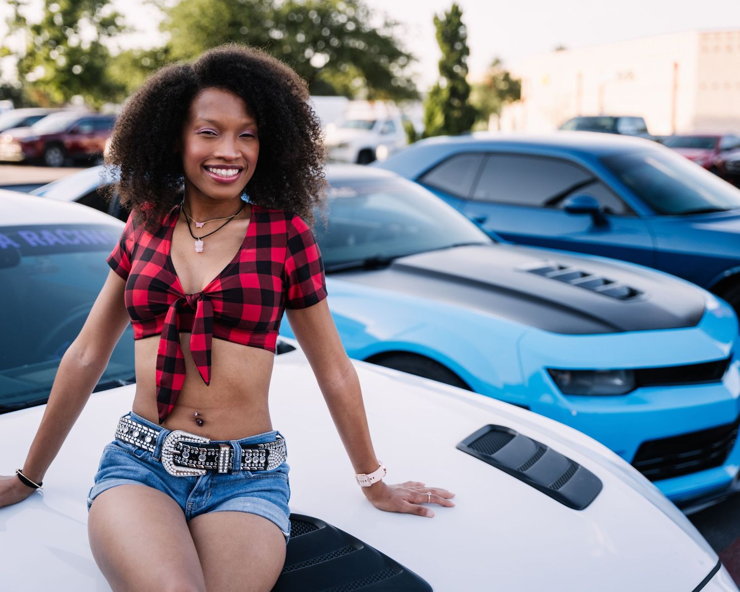 Modified sports cars showcased at daytime car meet event.