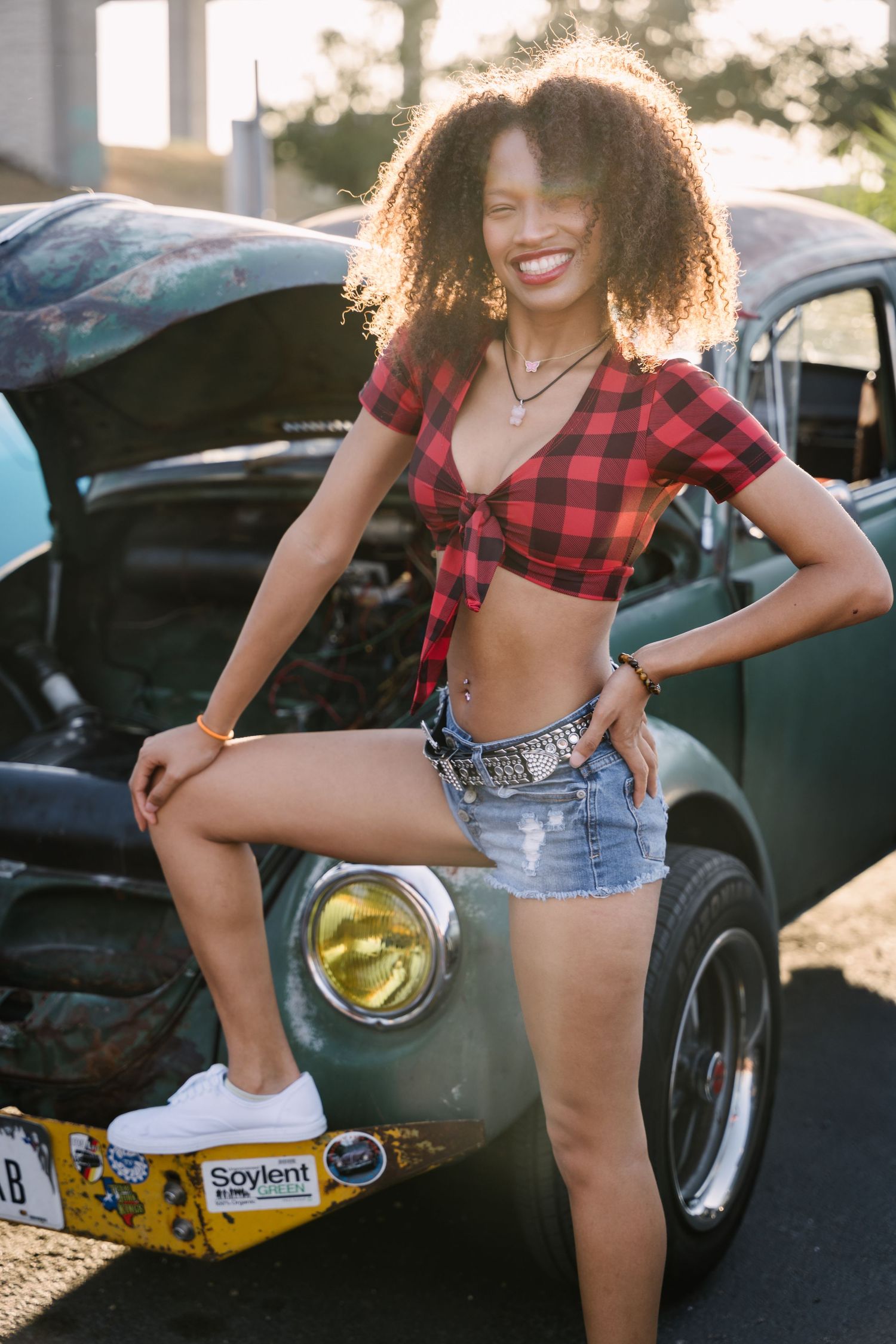 Retro car photoshoot featuring casual summer fashion and classic automobile.