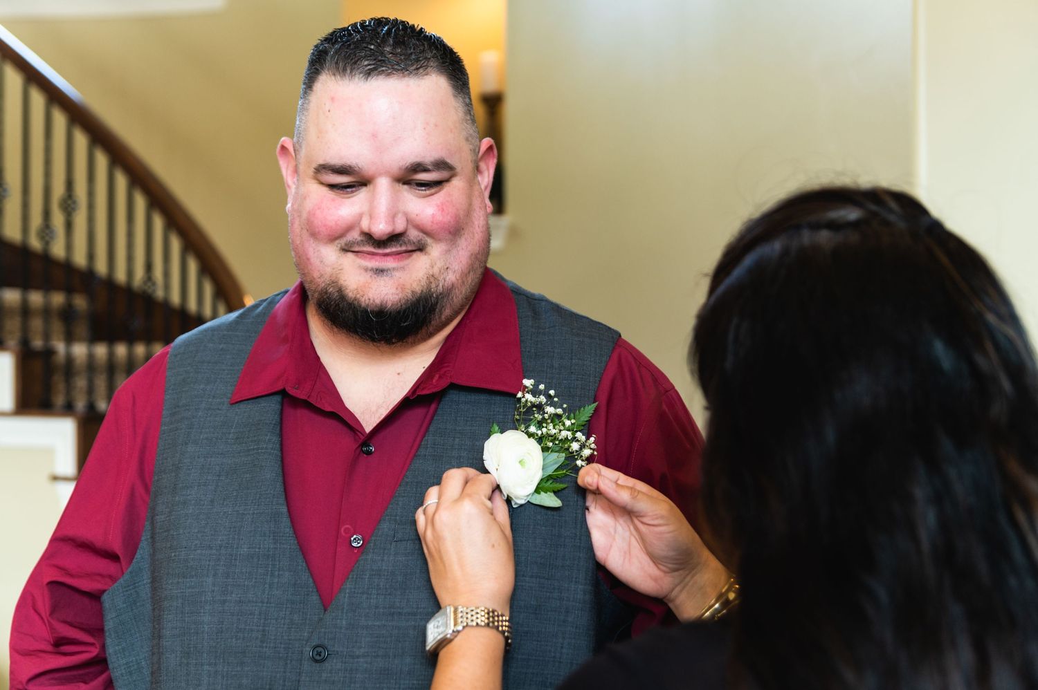 A corsage being pinned on at a formal event.