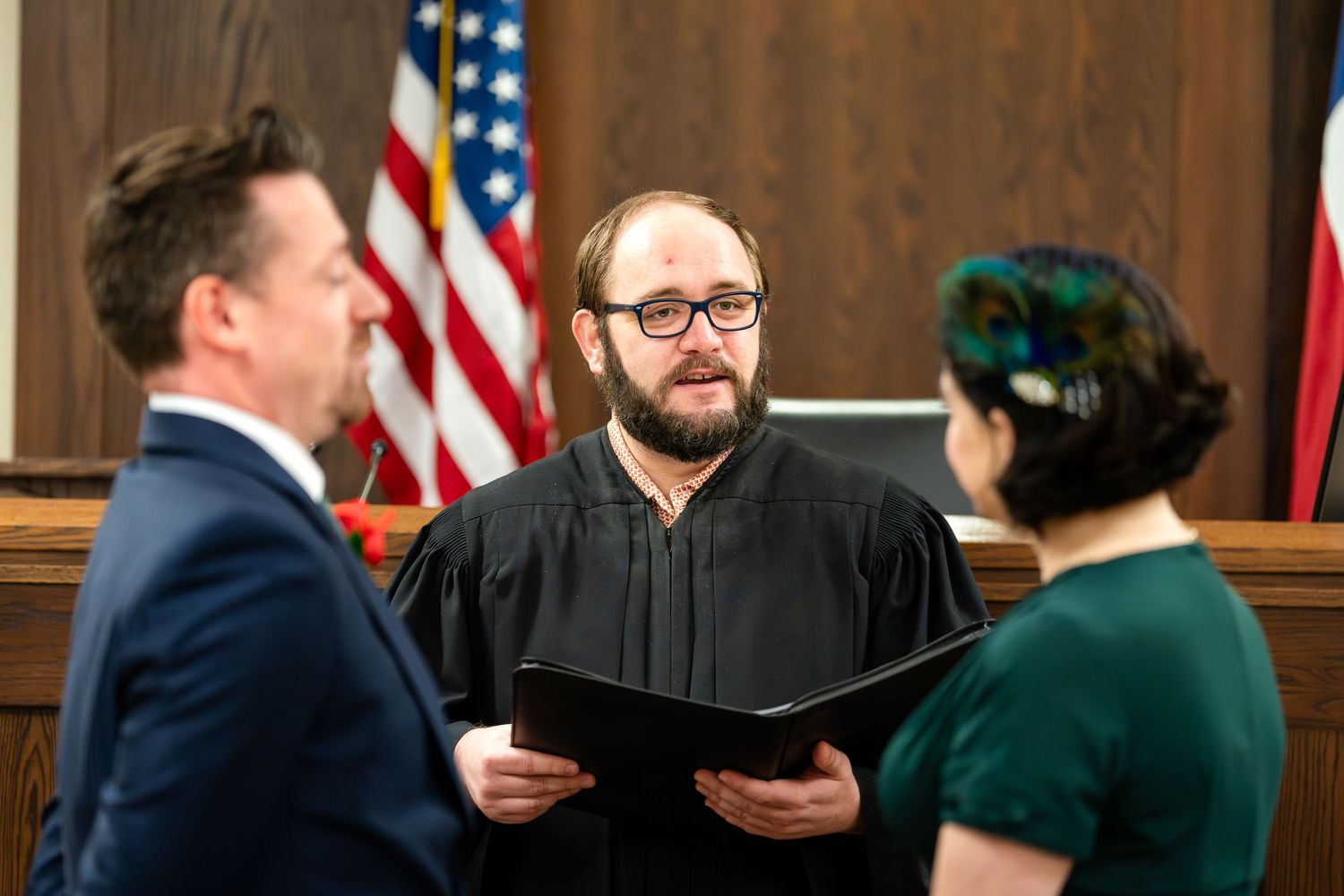 A judge presides over an intimate courthouse wedding ceremony.