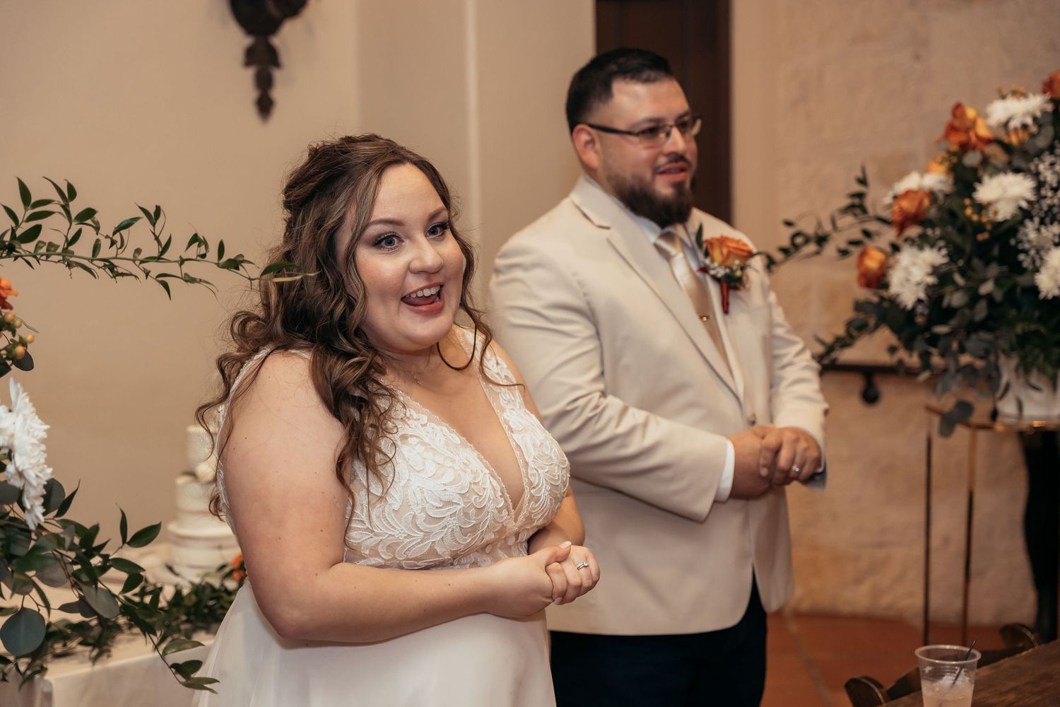 Wedding couple reacts with joy during their reception celebration.