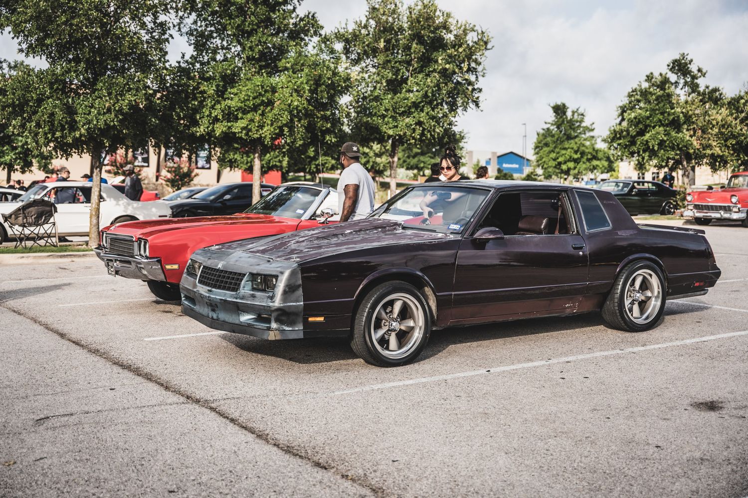 Classic Chevrolet Monte Carlo in black with custom wheels at a car show.