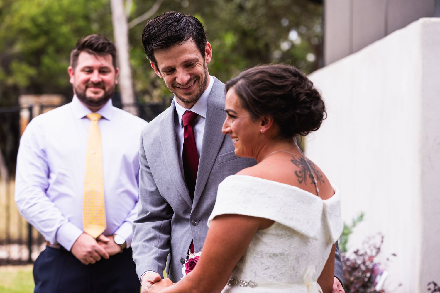 Wedding celebration moment outdoors with guests in formal attire.