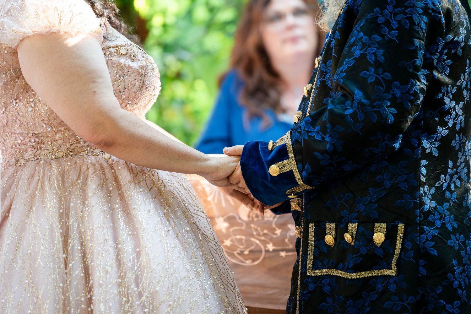 Wedding guests dancing and celebrating together at an outdoor reception in a natural setting.