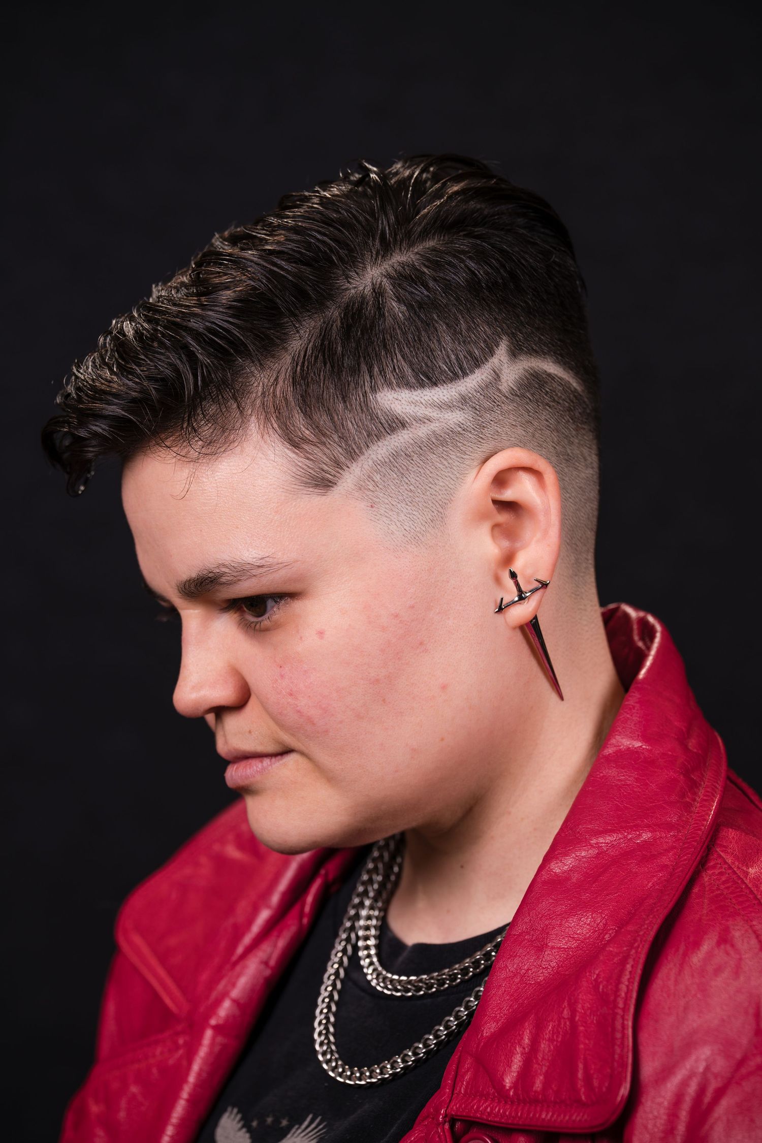 A series of profile portraits showing someone wearing a red leather jacket and silver chain necklace against a black background.