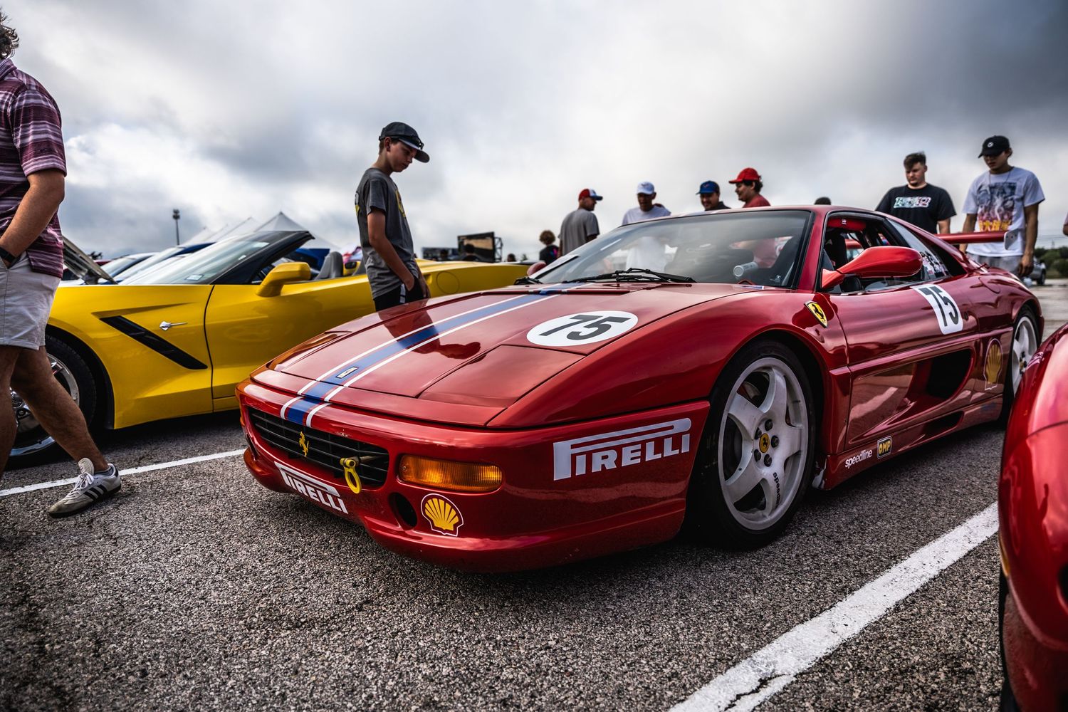 Classic red Ferrari F355 Challenge race car displayed at an outdoor automotive event.