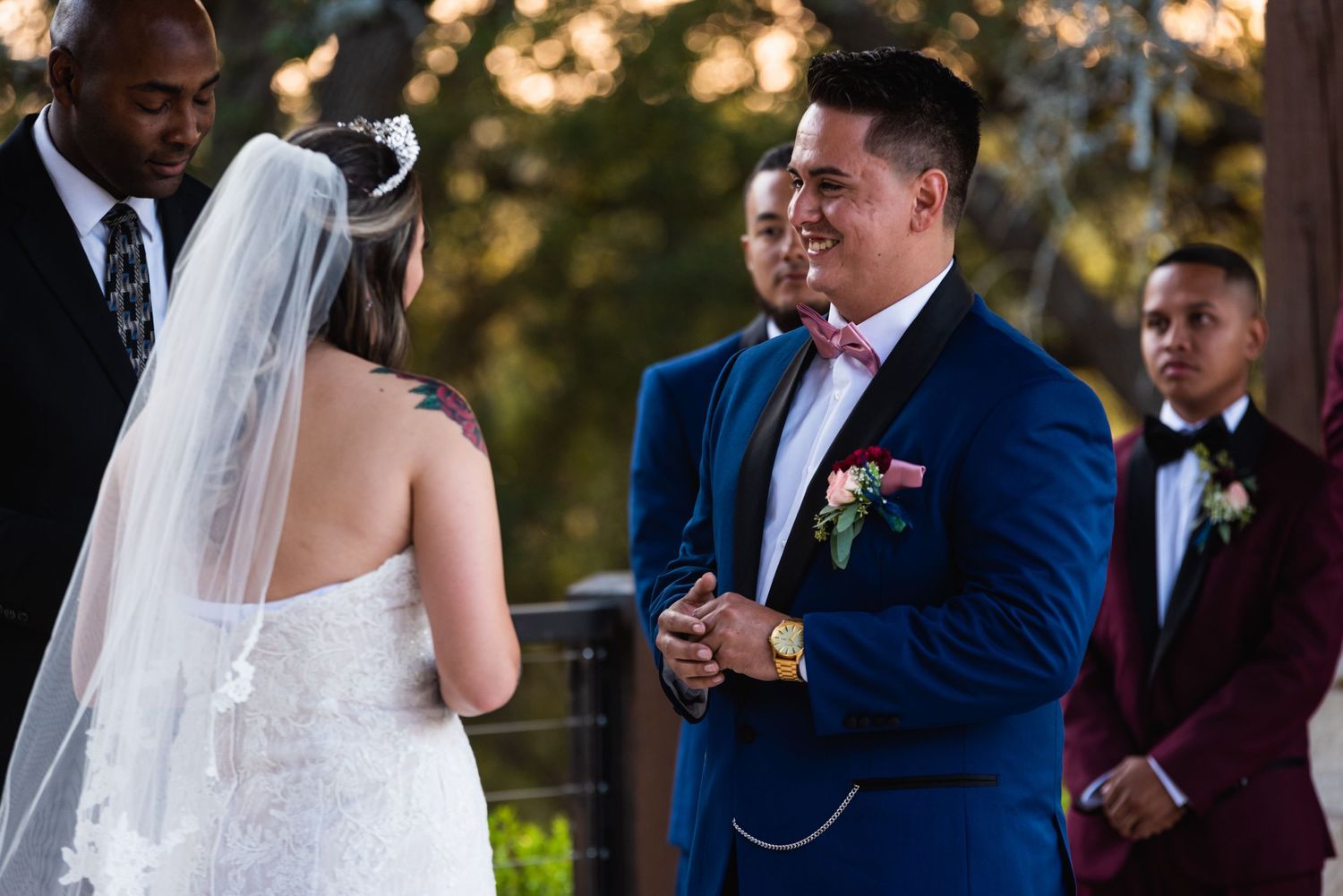 A wedding ceremony moment captured during golden hour under trees.