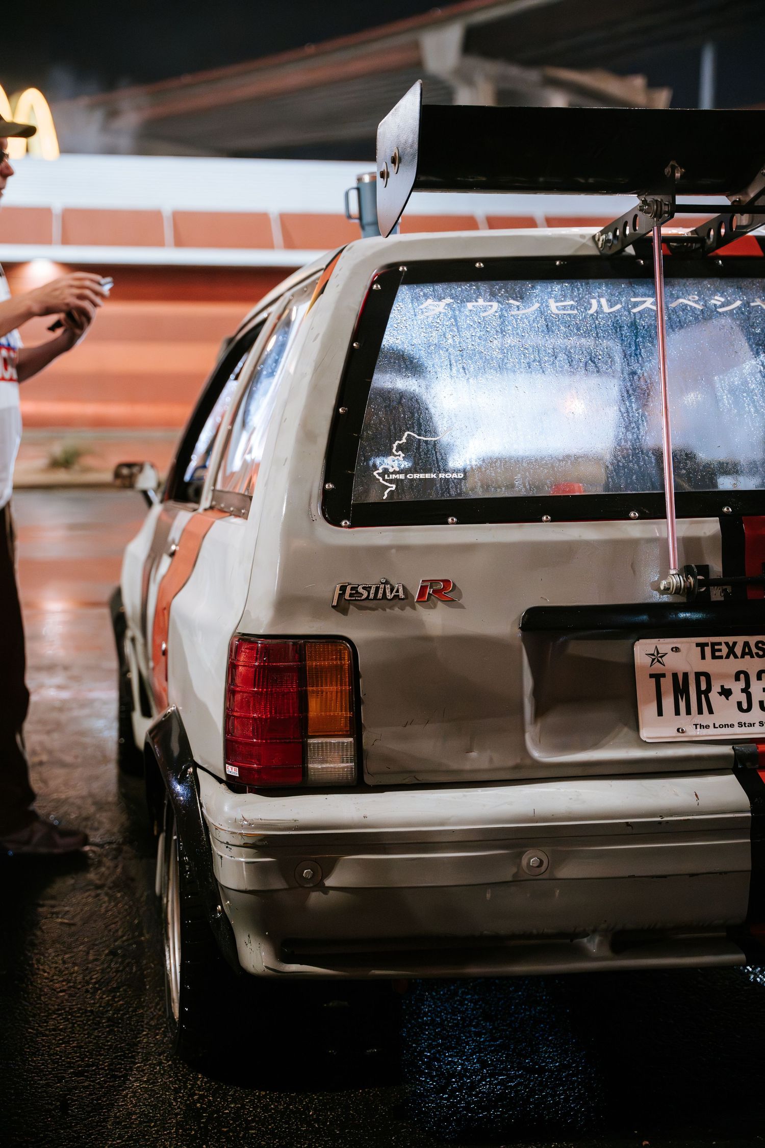 Rear view of a vintage Toyota 4Runner SUV with Japanese text on the window.