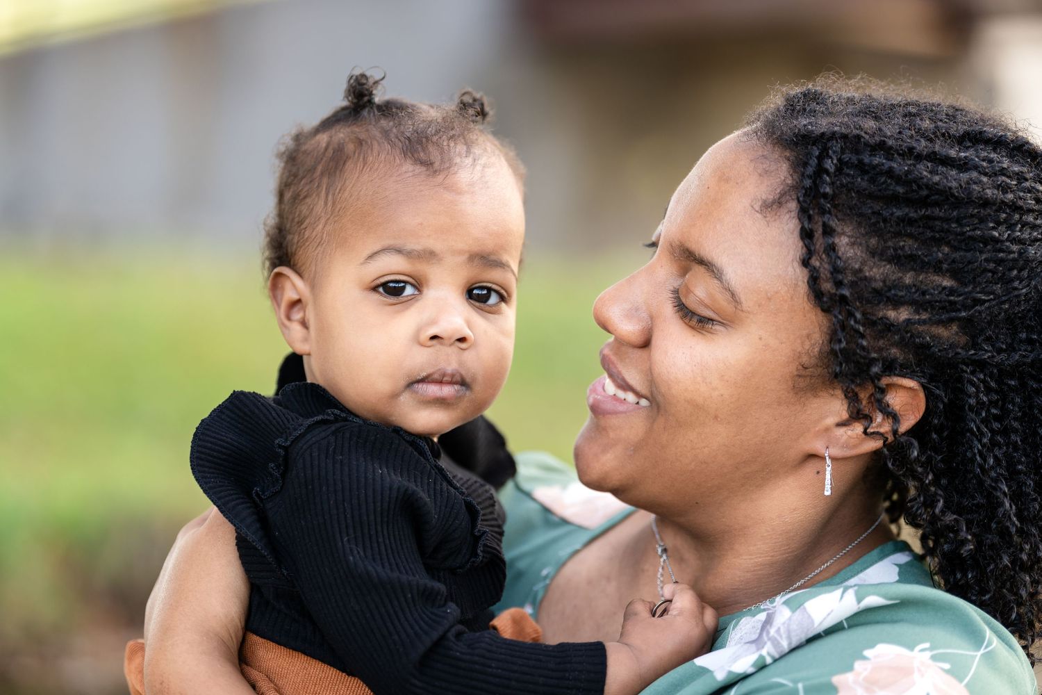A tender moment shared with a young child in a black sweater.