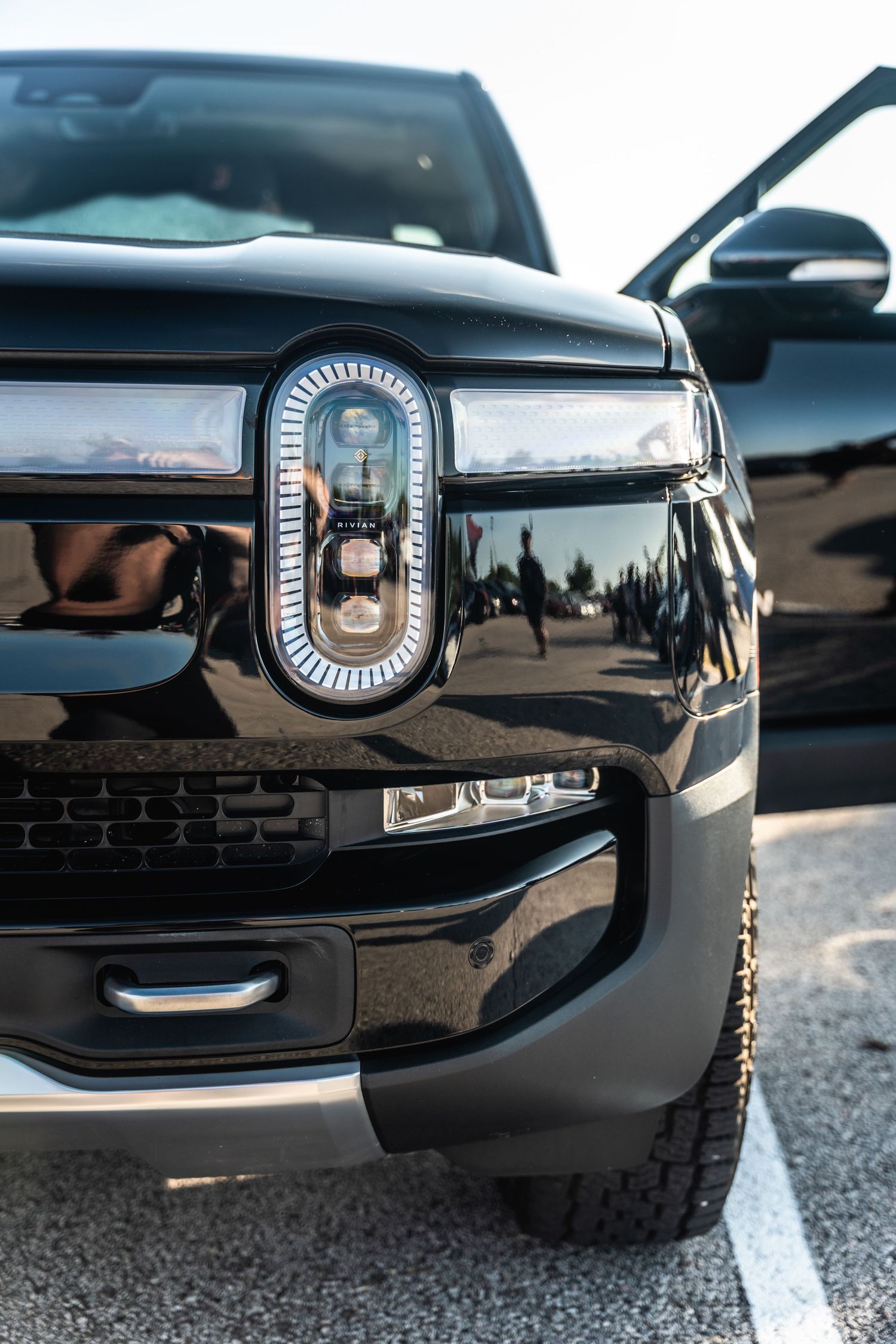 Close-up of modern black SUV front grille with LED lighting detail.