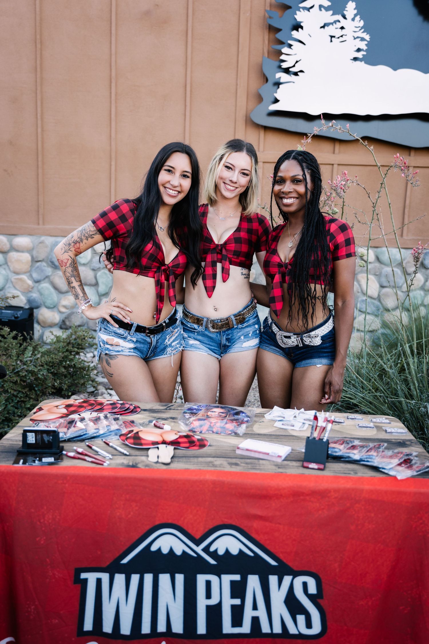 Promotional event setup with Twin Peaks branded table display outdoors.