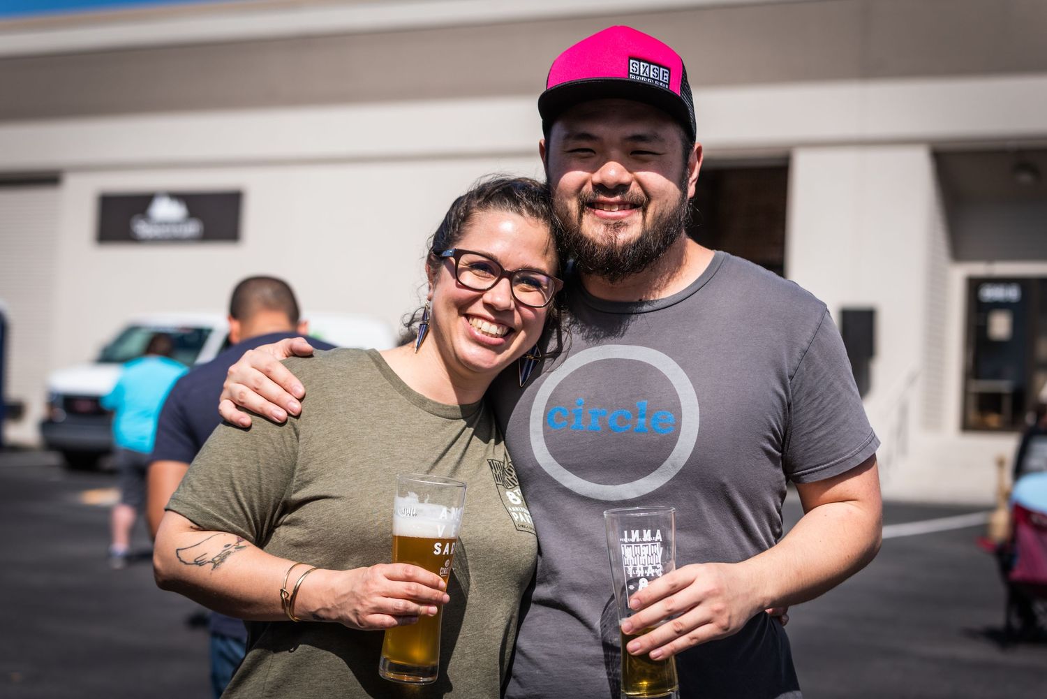 A couple enjoying beers at Circle Brewing Company's outdoor event.