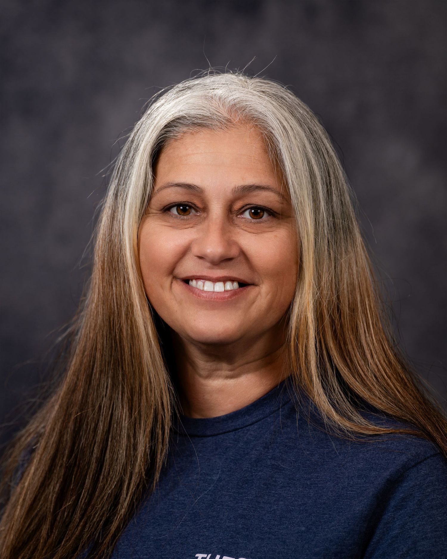Professional headshot portraits showing different poses and expressions against a dark background.