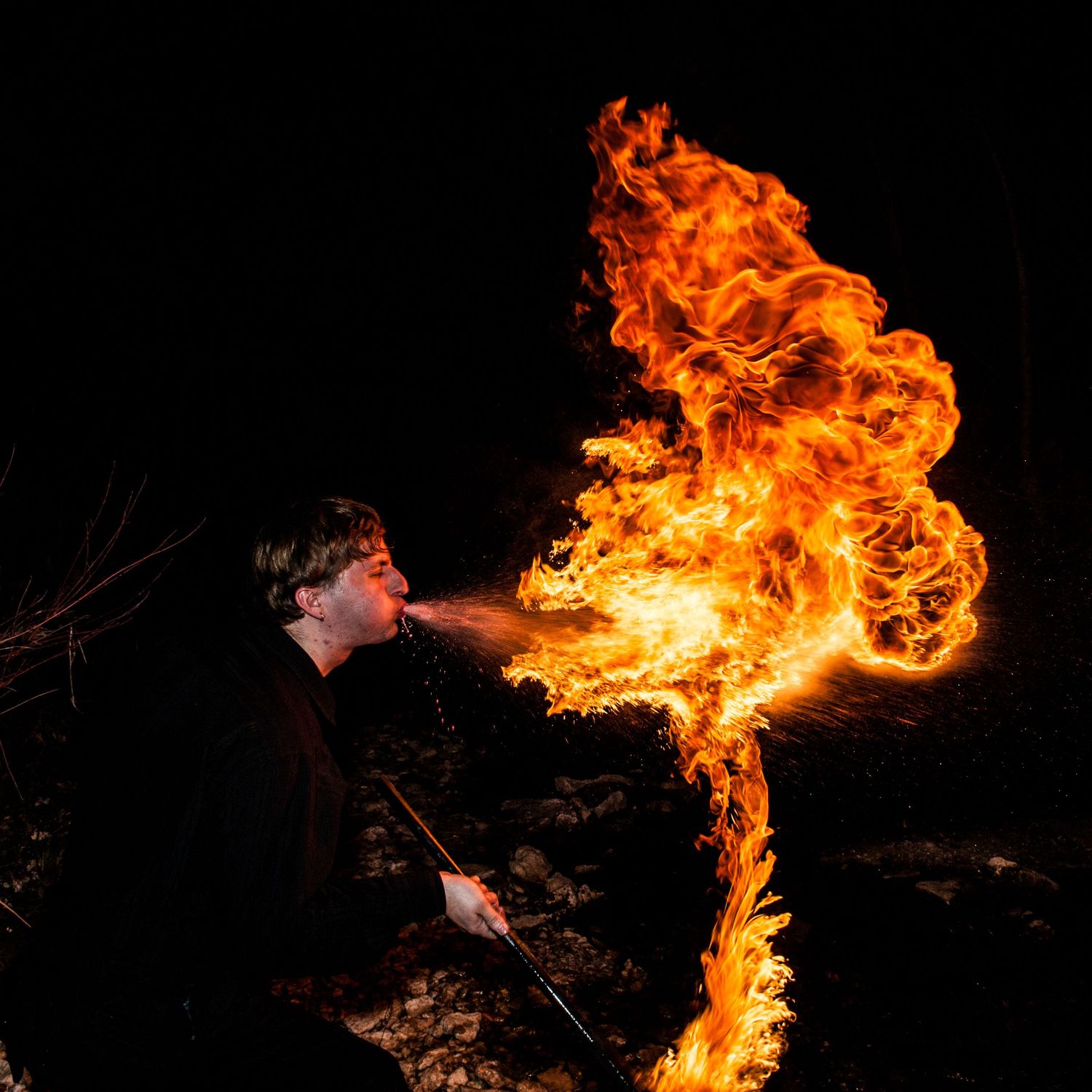 A series of five dark photos showing bright orange flames against a black background creating dramatic fire effects.