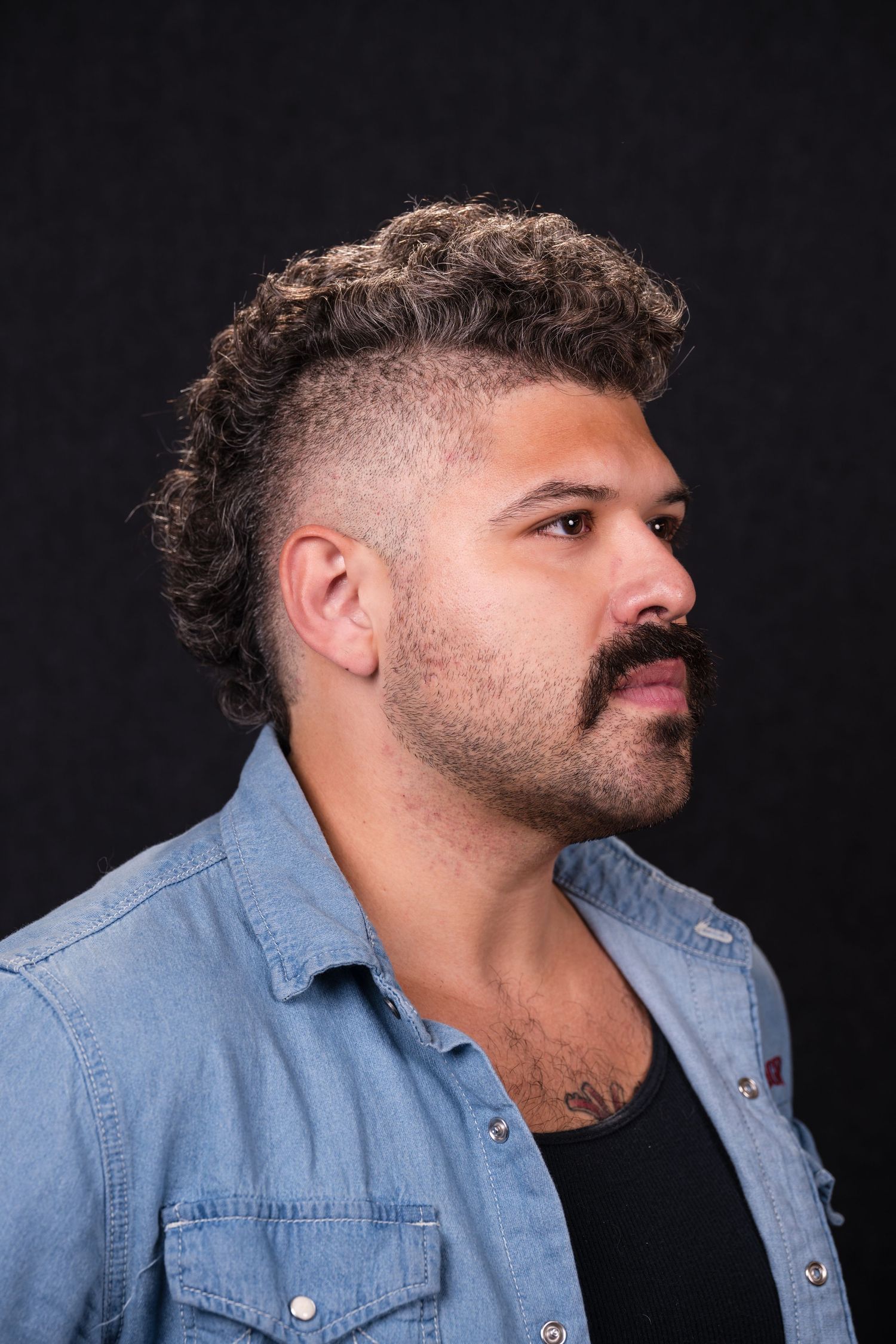 Profile views of person wearing light denim shirt against dark background showing different angles and facial expressions.